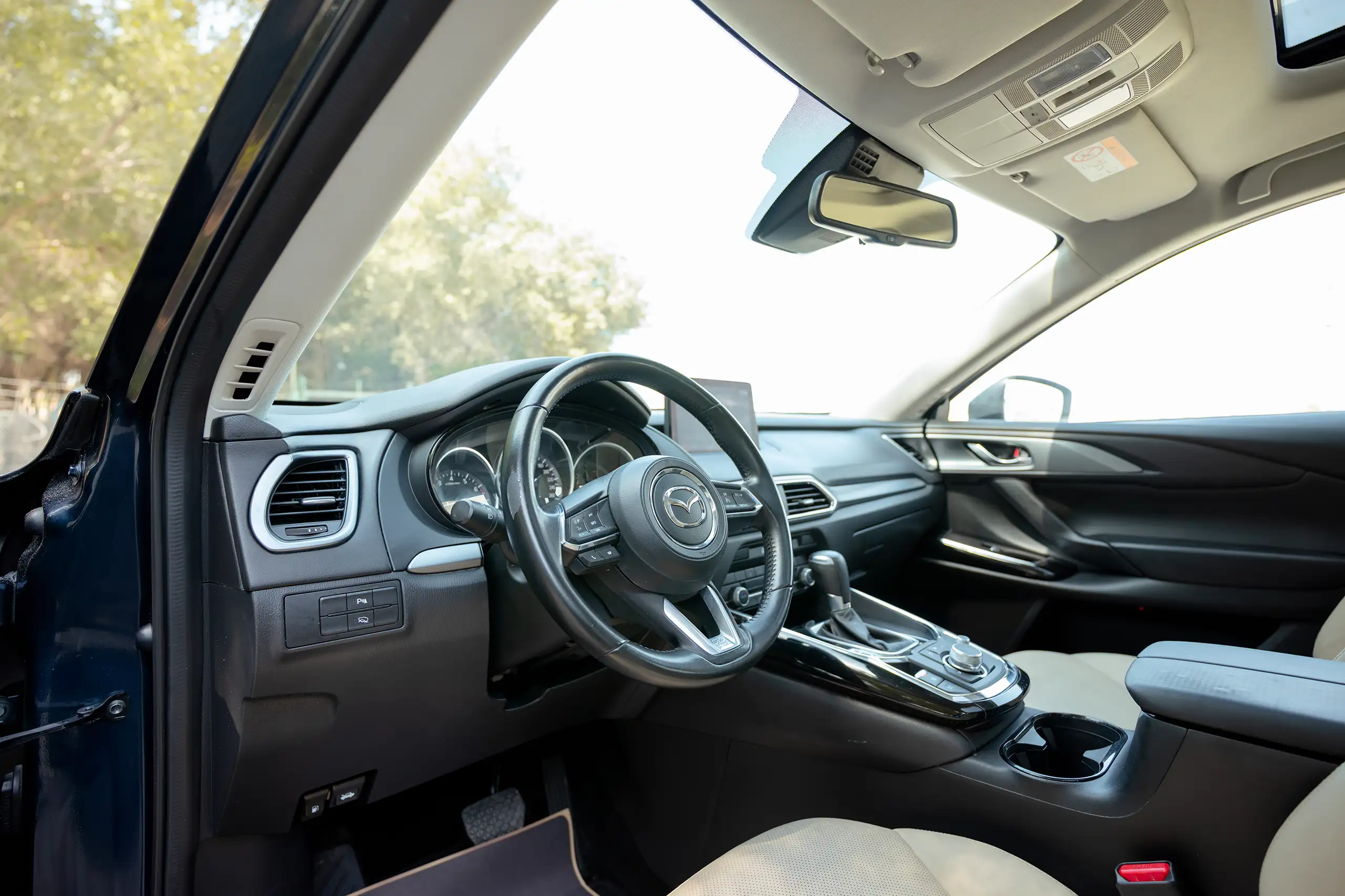 Used 2023 Mazda CX-9 GT in Blue – Driver Side Dashboard & Steering View for Sale at First Choice Cars Dubai Sharjah