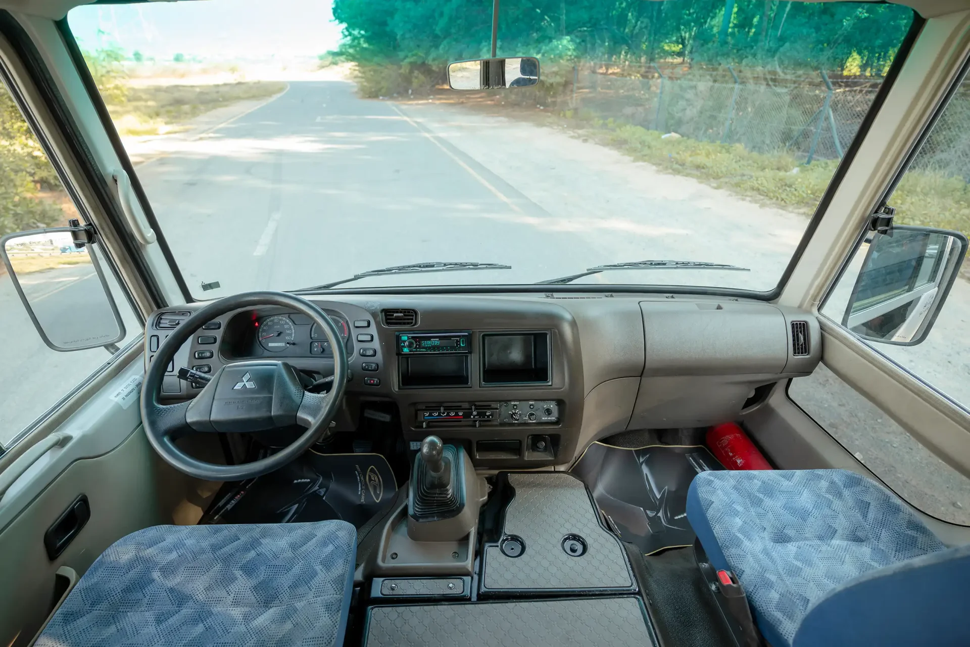 Used 2022 Mitsubishi ROSA Passenger Bus in White – Front Cabin / Dashboard Full View for Sale at First Choice Cars Dubai Sharjah