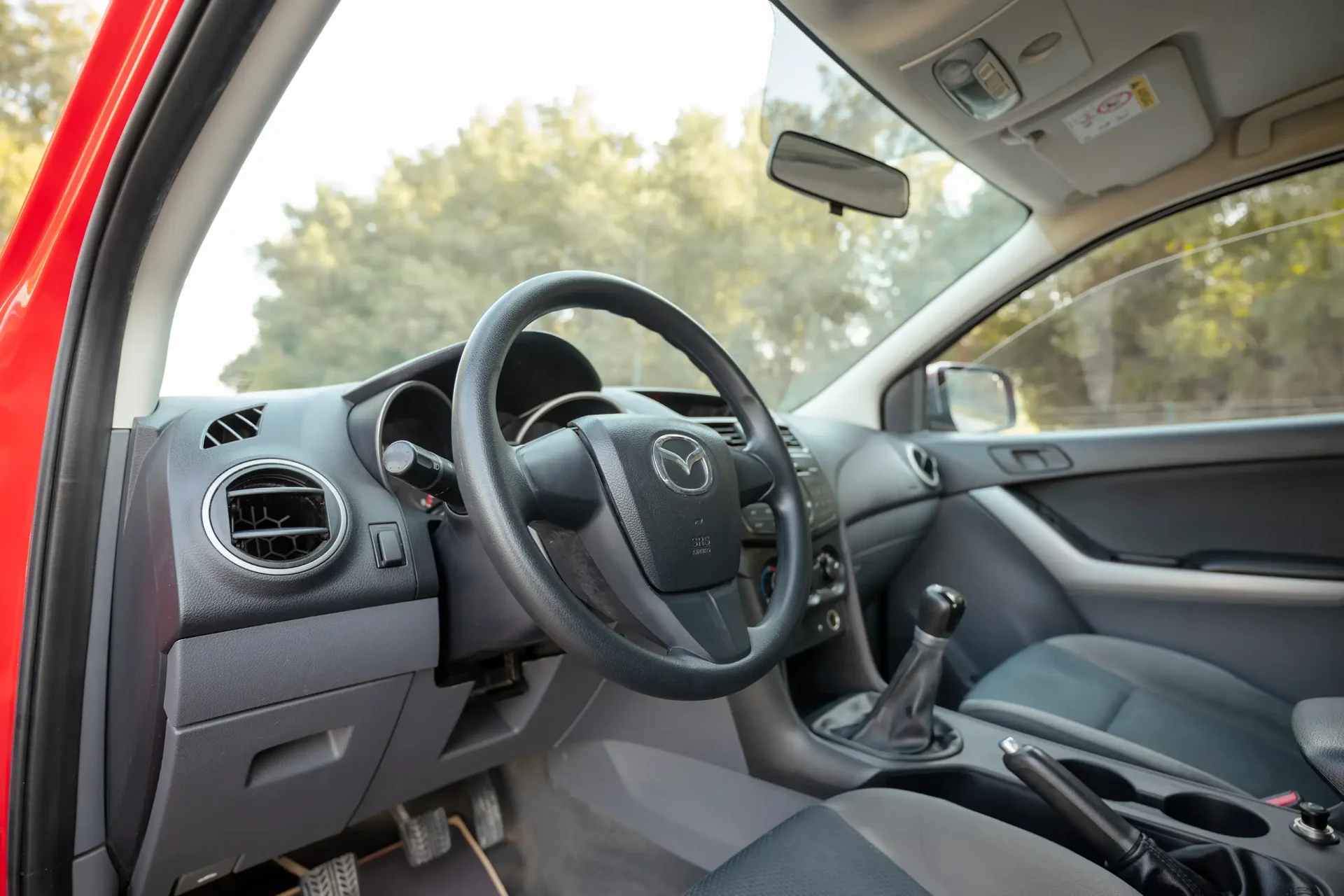 Used 2019 Mazda BT-50 XS in Red – Driver Side Dashboard & Steering View for Sale at First Choice Cars Dubai Sharjah
