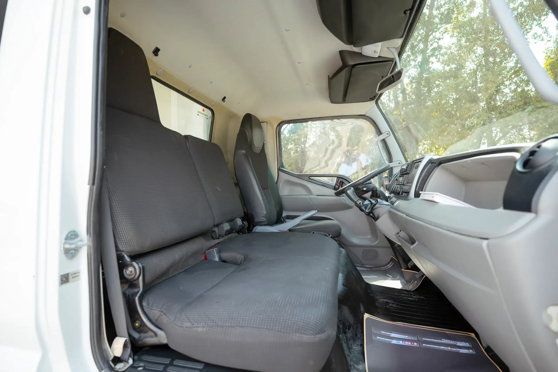 Used 2020 Mitsubishi Canter Freezer Box in White – Front Passenger Side Cabin View for Sale at First Choice Cars Dubai Sharjah