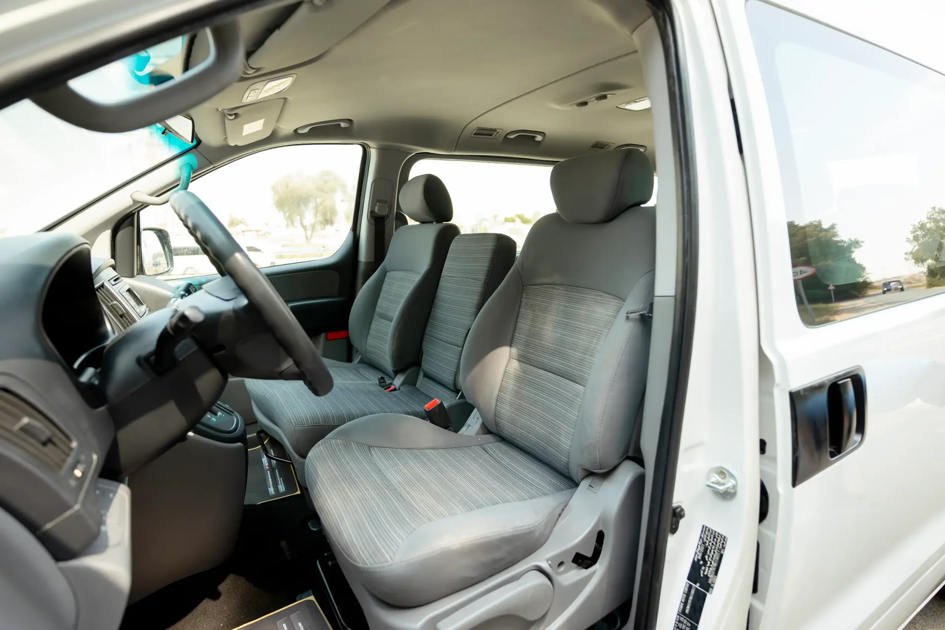 Used 2021 Hyundai H1 12-Seater Wagon in White – Front Driver Side Cabin View for Sale at First Choice Cars Dubai Sharjah