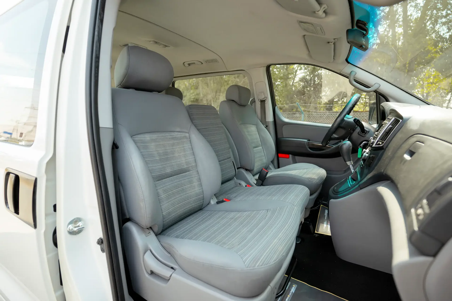 Used 2021 Hyundai H1 12-Seater Wagon in White – Front Passenger Side Cabin View for Sale at First Choice Cars Dubai Sharjah