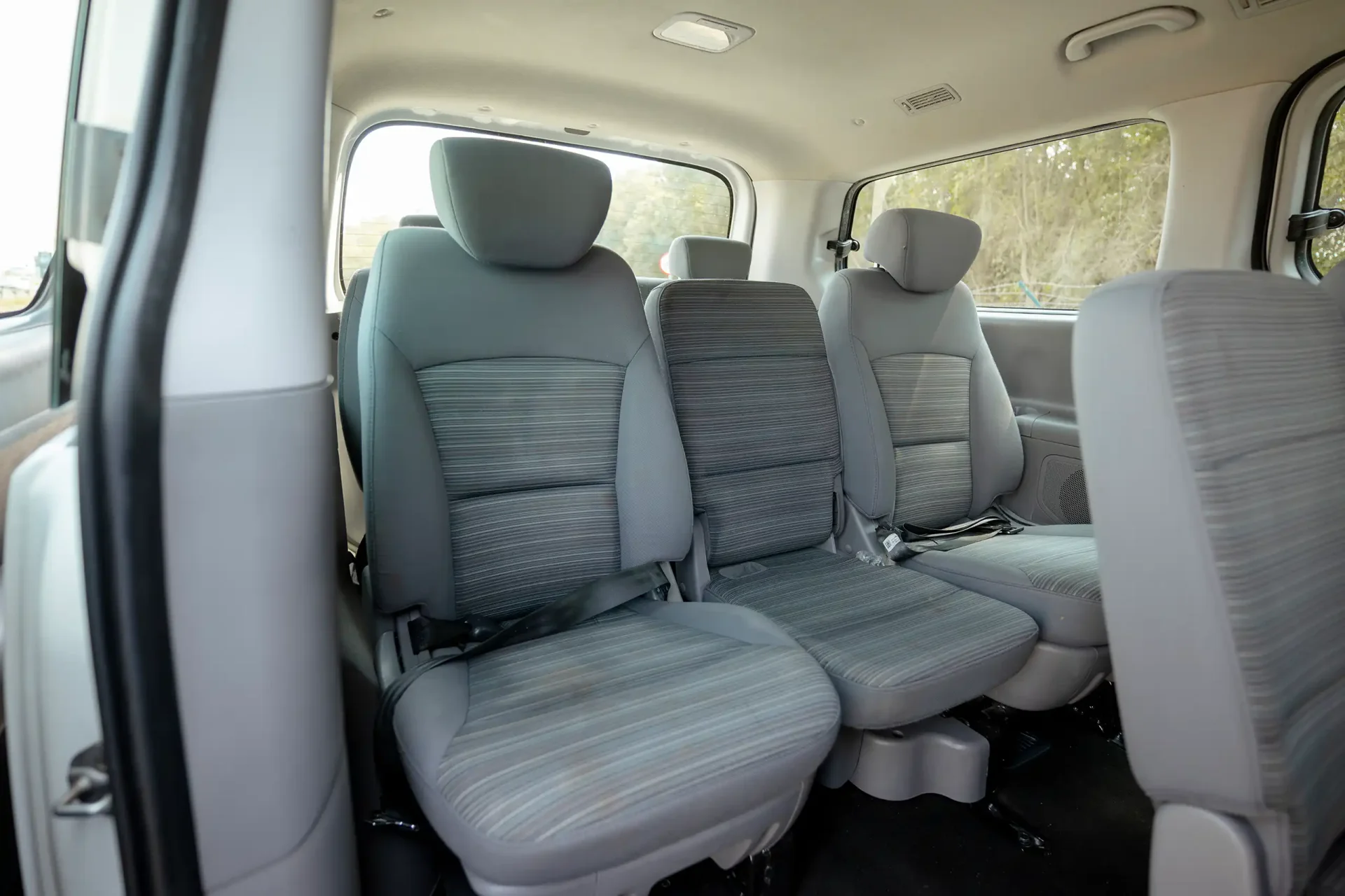 Used 2021 Hyundai H1 12-Seater Wagon in White – Third Row Right Seat View for Sale at First Choice Cars Dubai Sharjah
