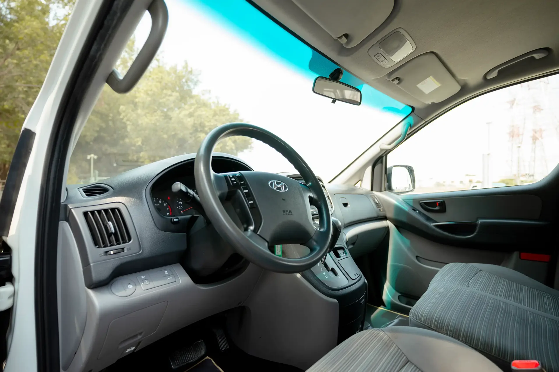 Used 2021 Hyundai H1 12-Seater Wagon in White – Driver Side Dashboard & Steering View for Sale at First Choice Cars Dubai Sharjah