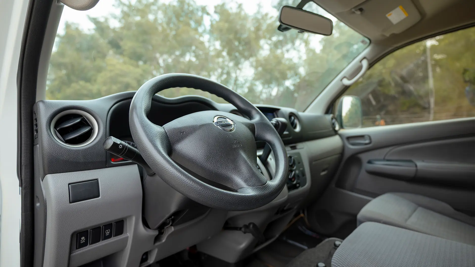 Used 2022 Nissan Urvan Standard Roof in White – Driver Side Dashboard & Steering View for Sale at First Choice Cars Dubai Sharjah