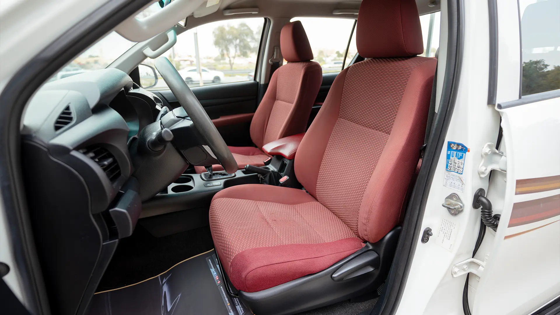 Used 2019 Toyota Hilux DLX Double Cabin in White – Front Driver Side Cabin View for Sale at First Choice Cars Dubai Sharjah