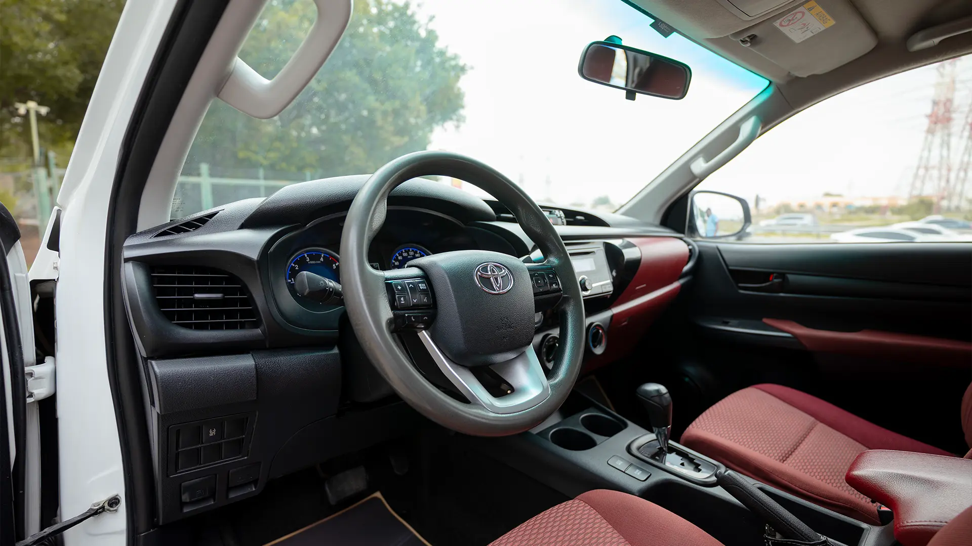 Used 2019 Toyota Hilux DLX Double Cabin in White – Driver Side Dashboard & Steering View for Sale at First Choice Cars Dubai Sharjah
