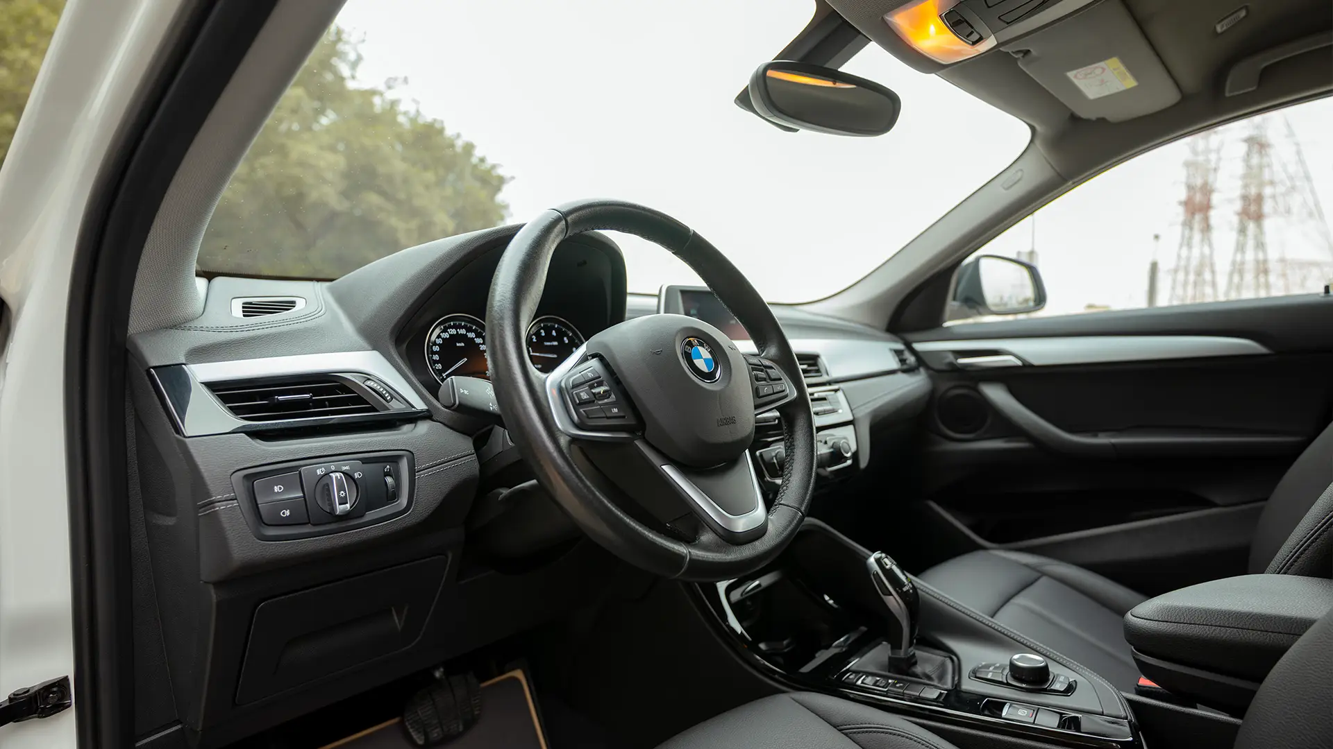 Used 2020 BMW X2 S-Drive 20i in White – Driver Side Dashboard & Steering View for Sale at First Choice Cars Dubai Sharjah