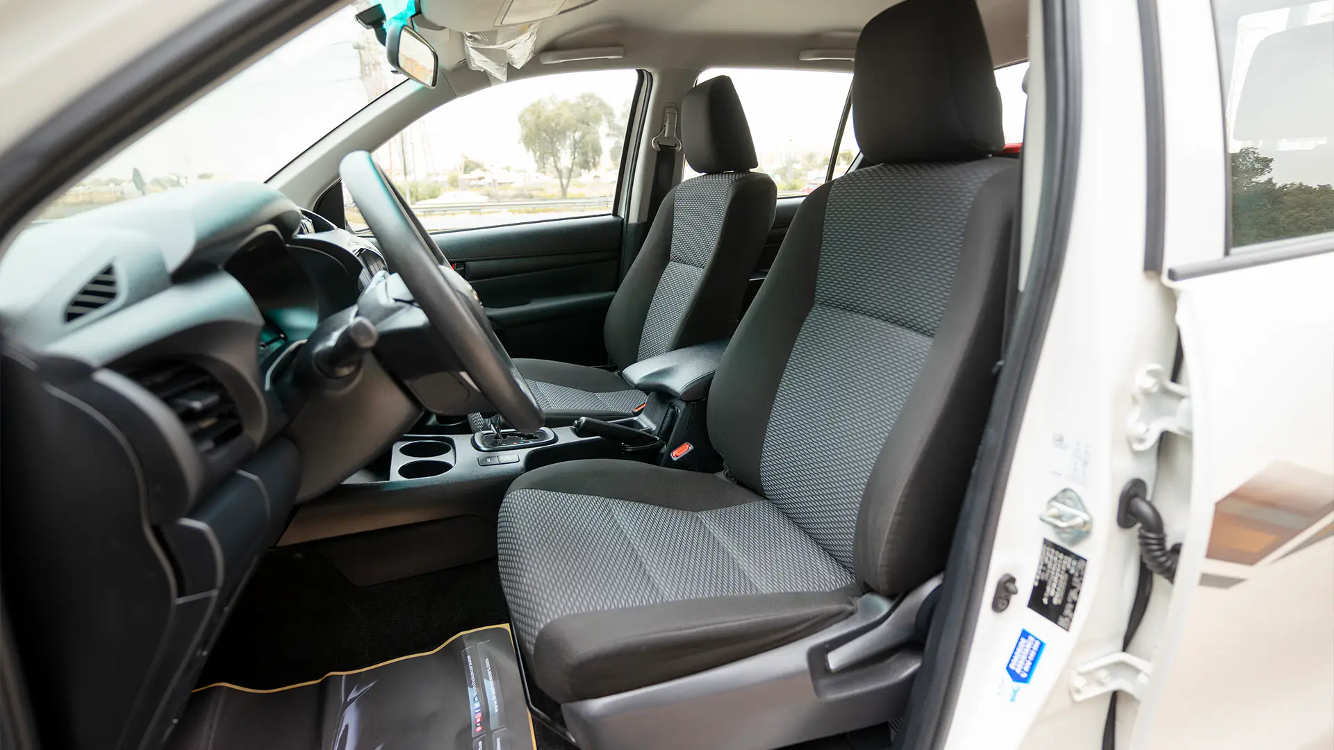 Used 2024 Toyota Hilux GL Double Cabin in White – Front Driver Side Cabin View for Sale at First Choice Cars Dubai Sharjah