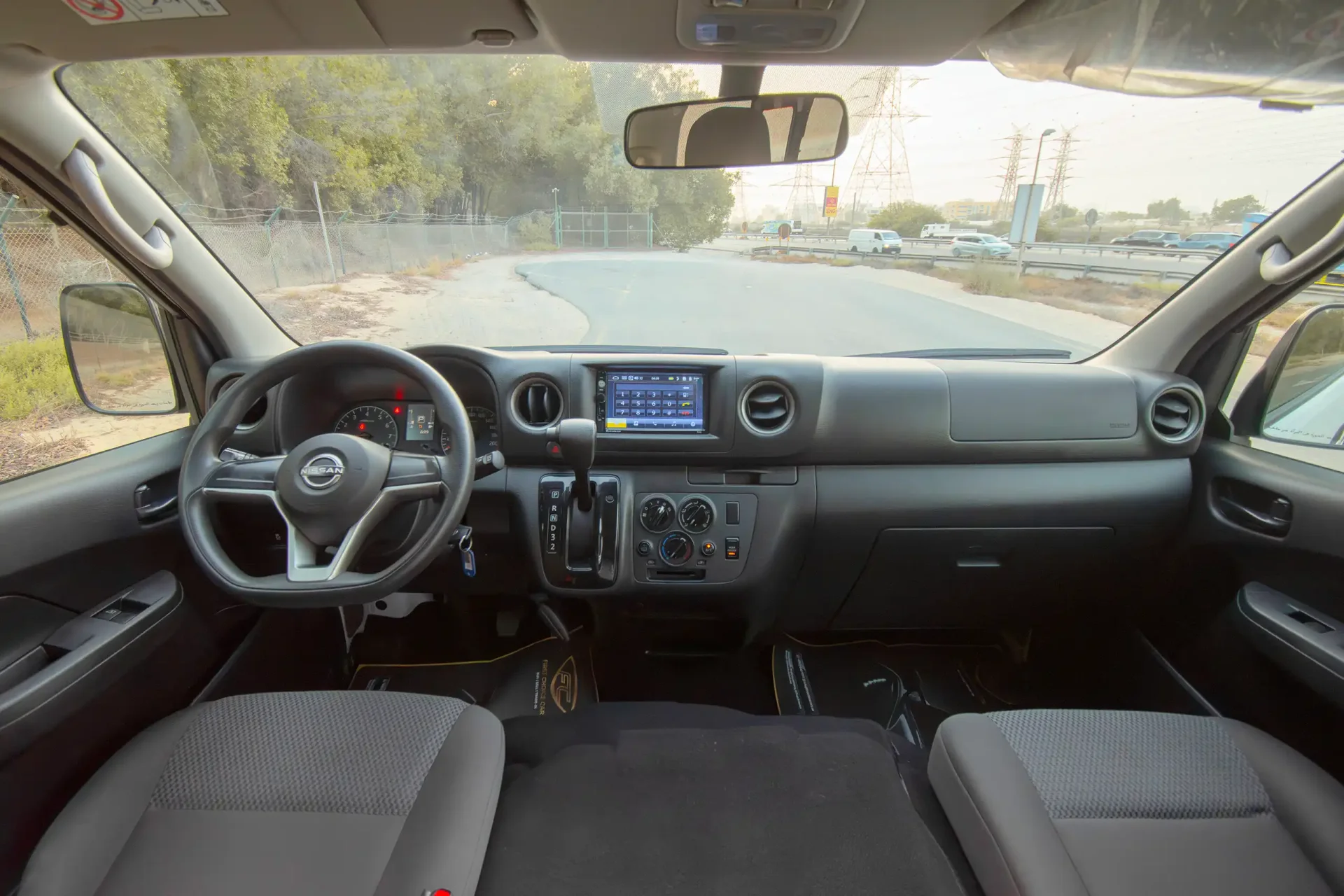 Used 2023 Nissan Urvan High Roof in White – Front Cabin / Dashboard Full View for Sale at First Choice Cars Dubai Sharjah