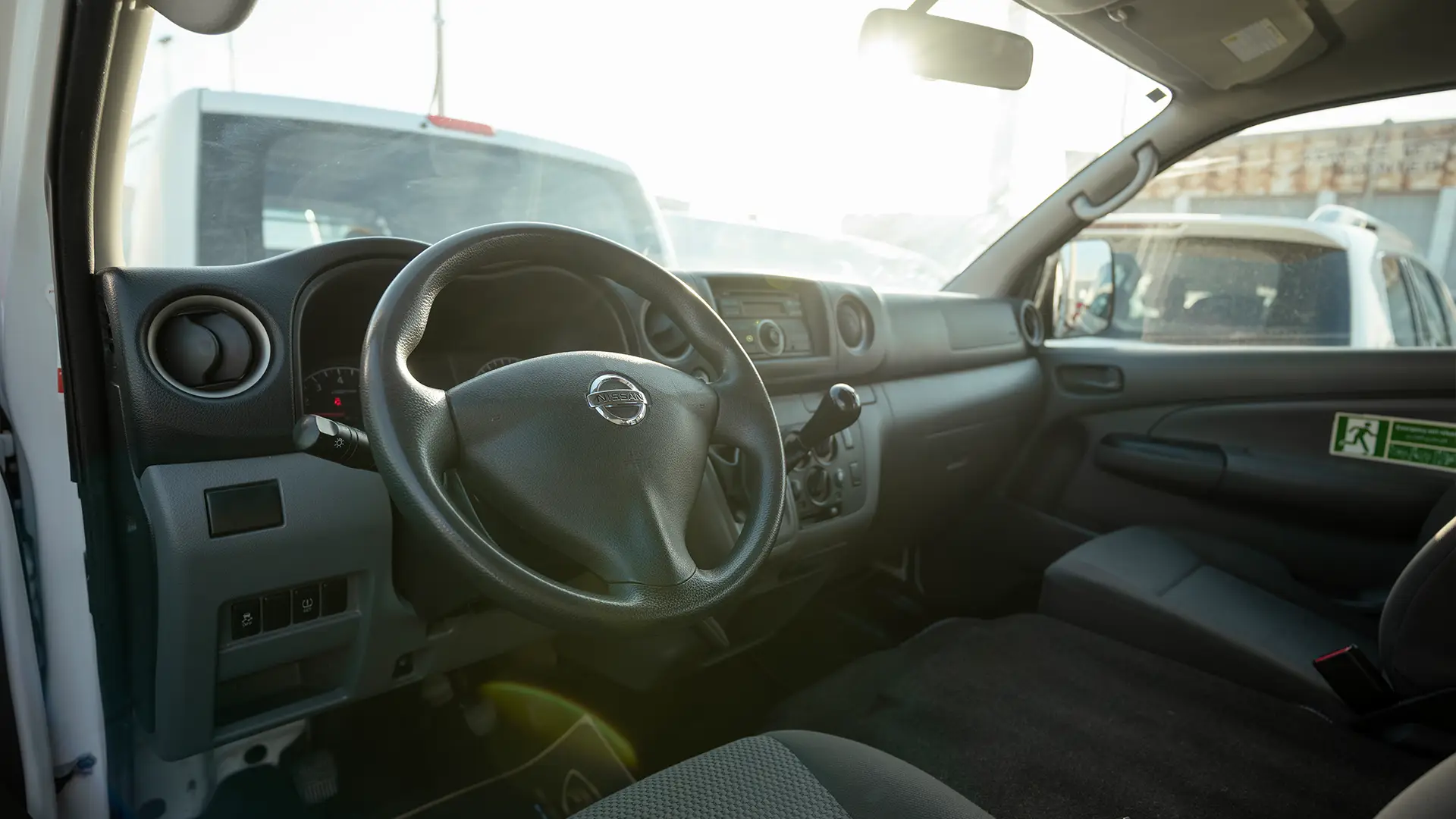 Used 2019 Nissan Urvan High Roof in White – Driver Side Dashboard & Steering View for Sale at First Choice Cars Dubai Sharjah