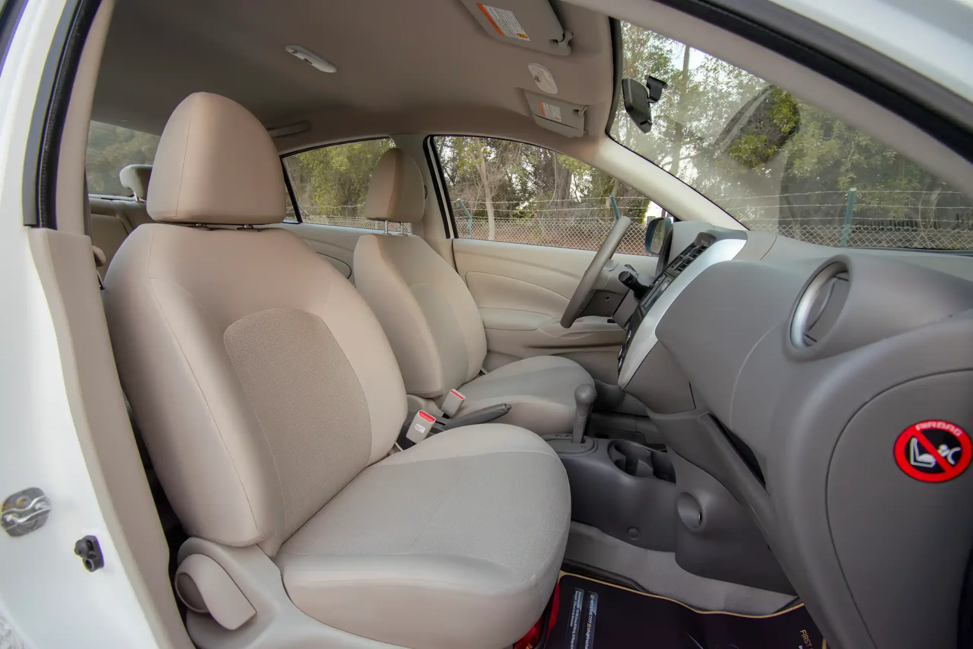 Used 2023 Nissan Sunny SV in White – Front Passenger Side Cabin View for Sale at First Choice Cars Dubai Sharjah