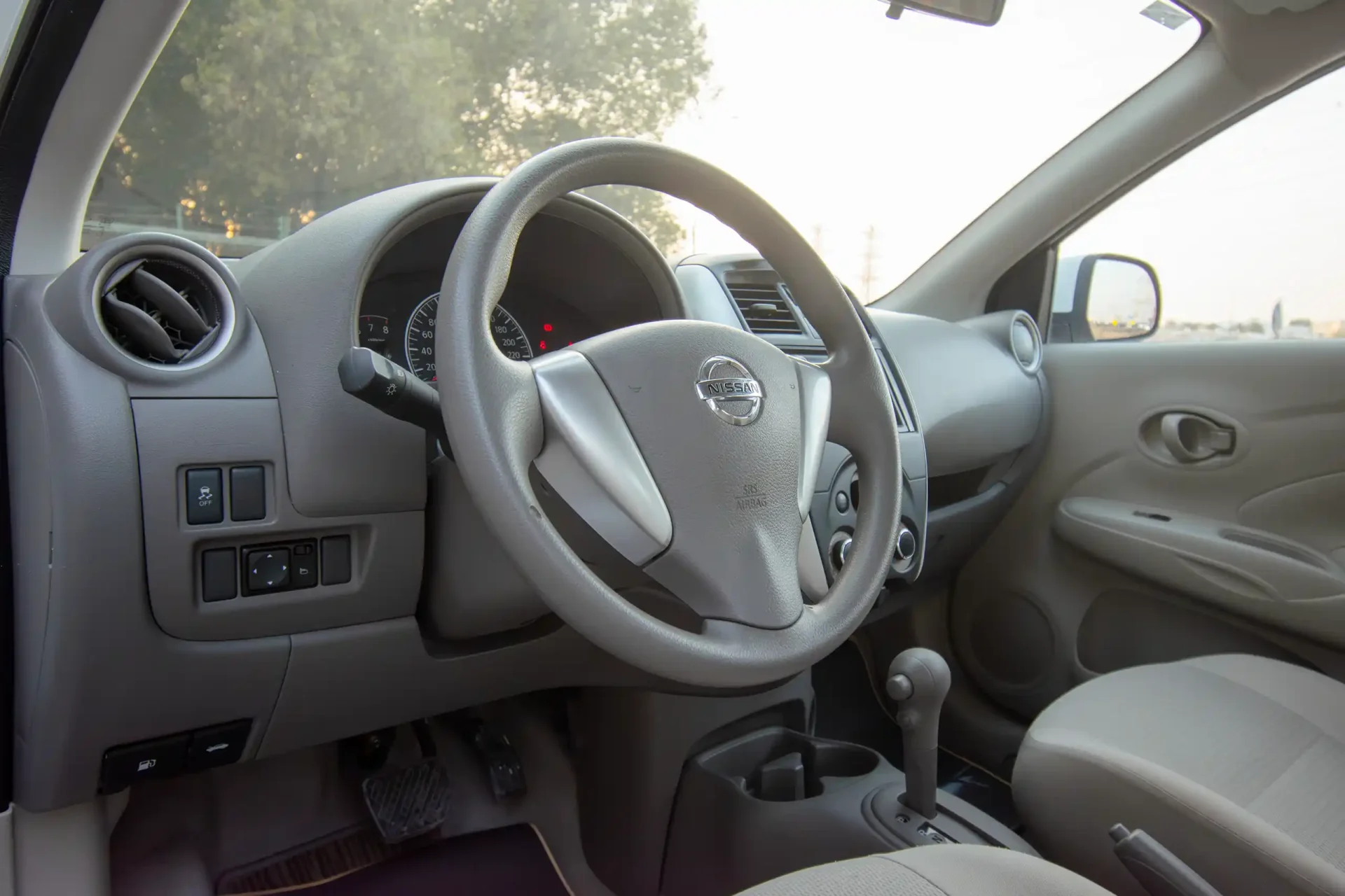 Used 2023 Nissan Sunny SV in White – Driver Side Dashboard & Steering View for Sale at First Choice Cars Dubai Sharjah