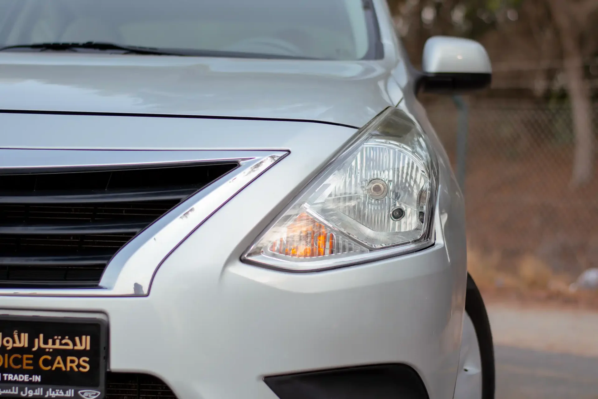Used 2022 Nissan Sunny SV in Silver – Headlight Close-up for Sale at First Choice Cars Dubai Sharjah