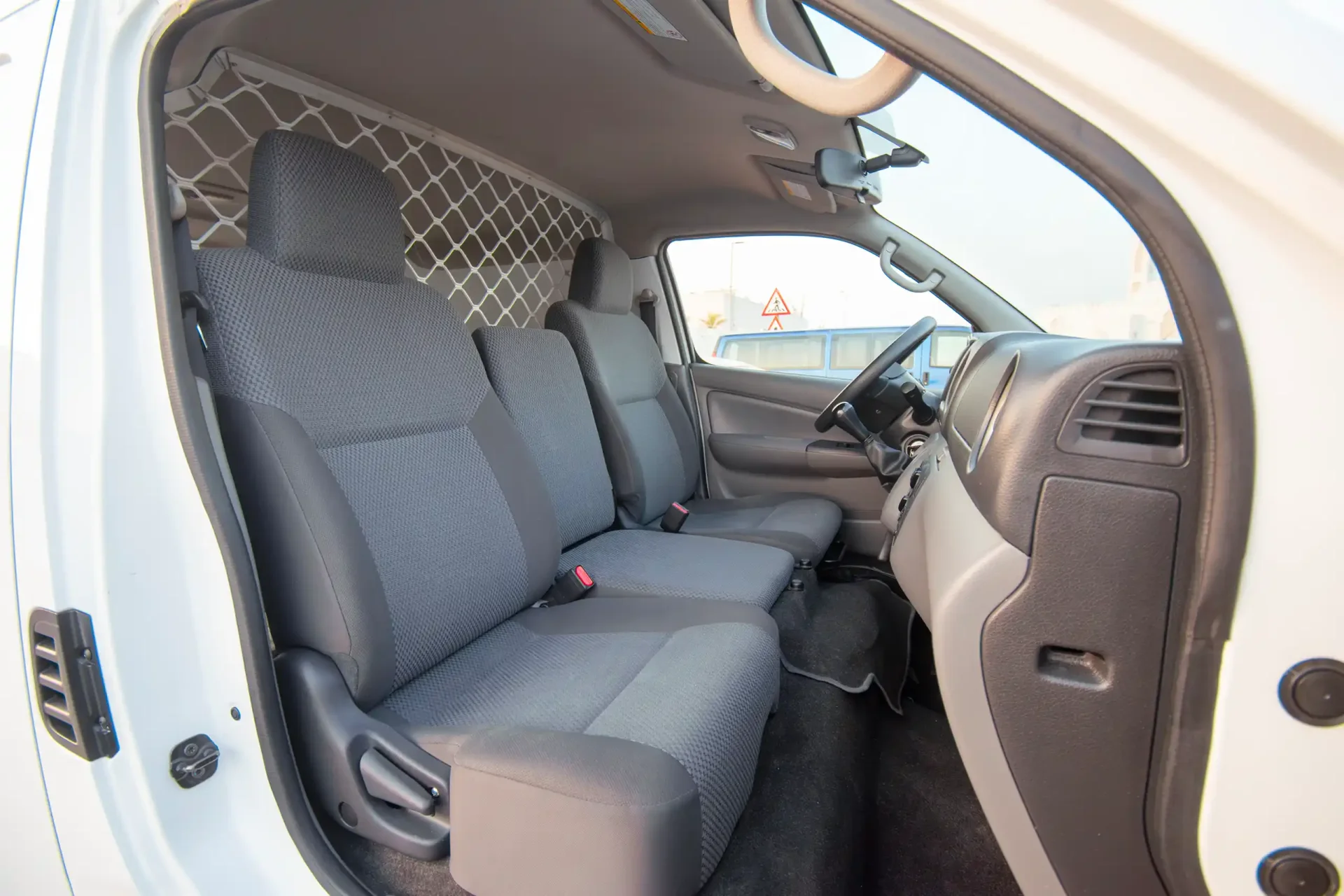 Used 2022 Nissan Urvan Standard Roof in White – Front Passenger Side Cabin View for Sale at First Choice Cars Dubai Sharjah