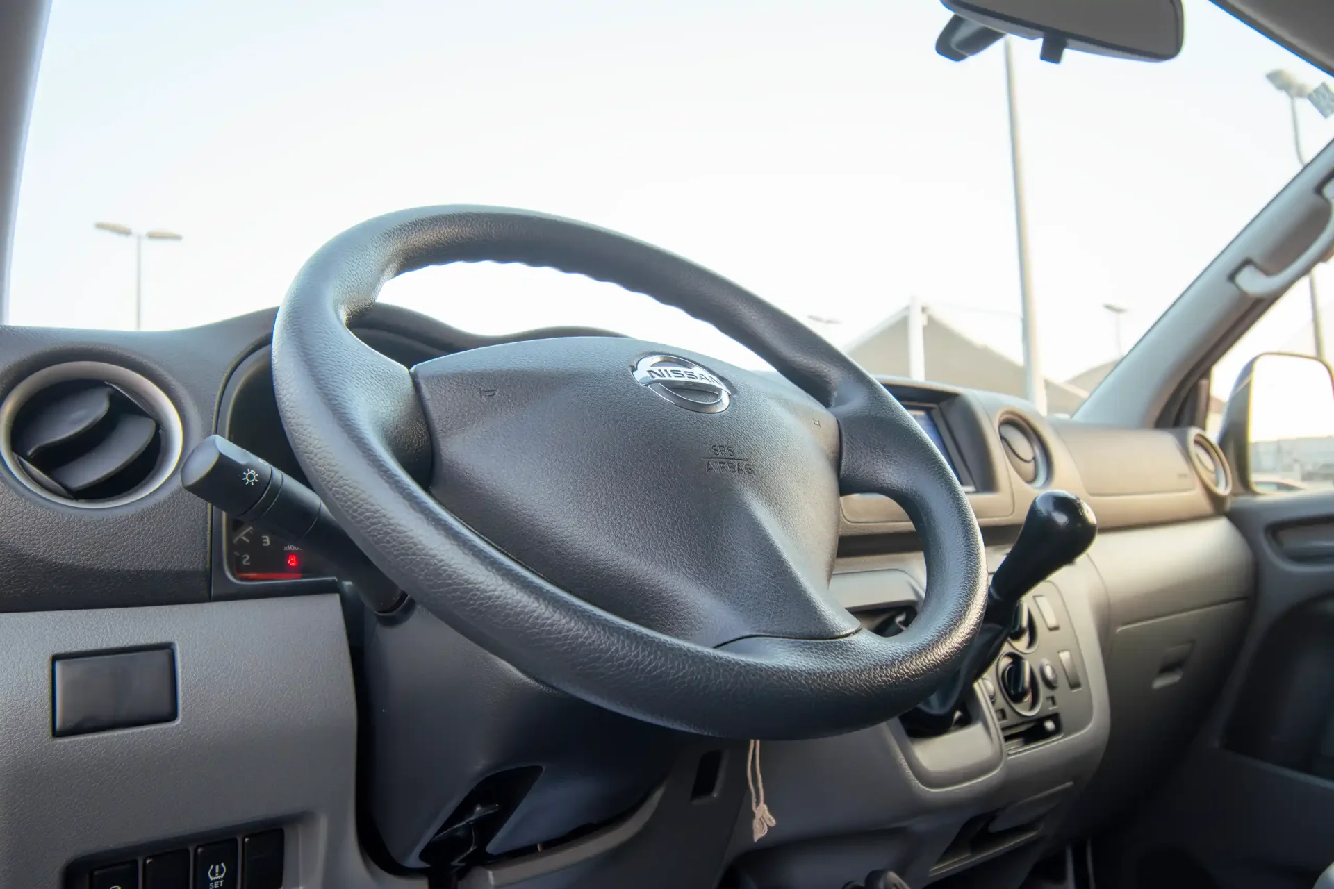 Used 2022 Nissan Urvan Standard Roof in White – Driver Side Dashboard & Steering View for Sale at First Choice Cars Dubai Sharjah