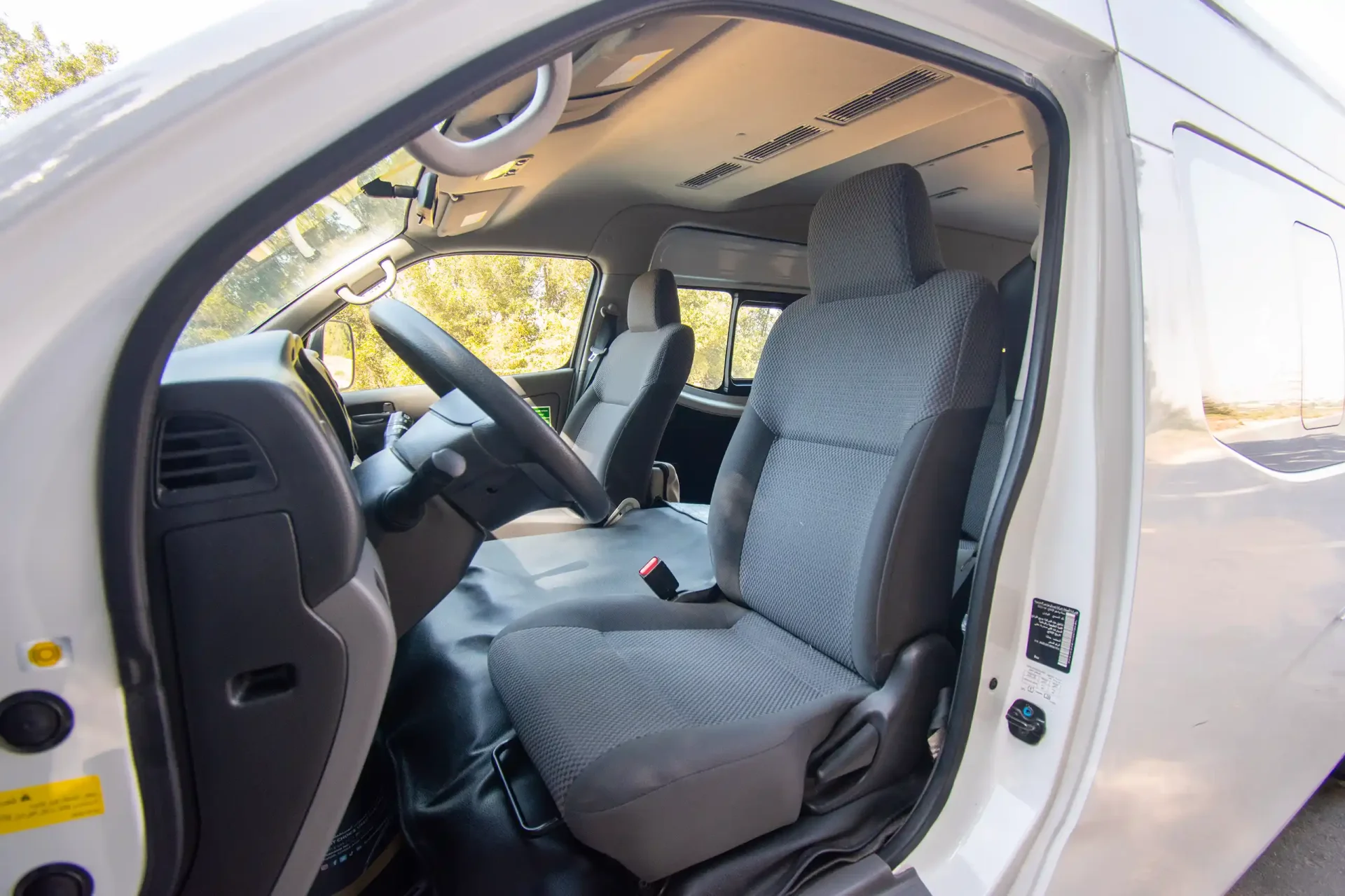 Used 2021 Nissan Urvan High Roof in White – Front Driver Side Cabin View for Sale at First Choice Cars Dubai Sharjah
