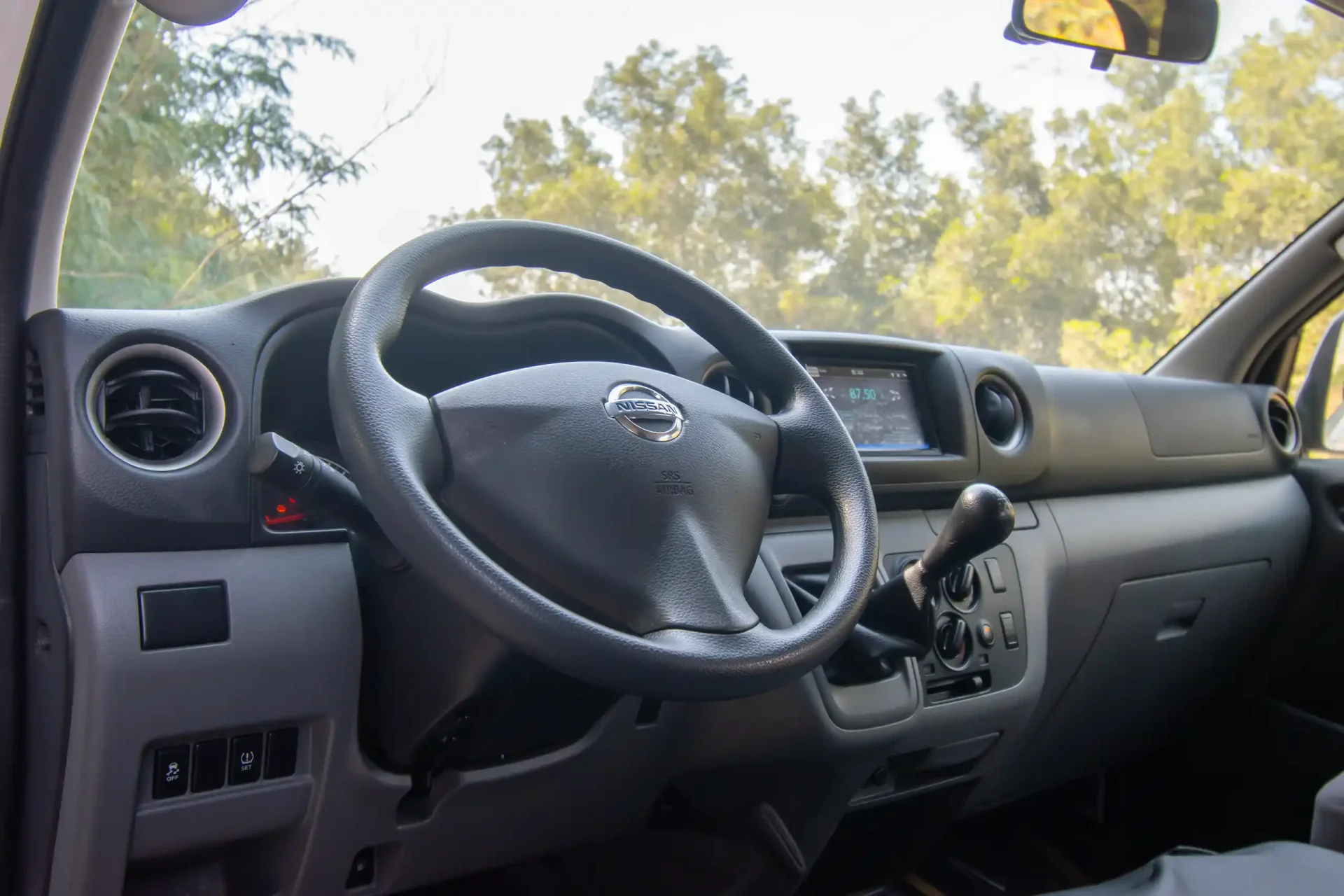 Used 2021 Nissan Urvan High Roof in White – Driver Side Dashboard & Steering View for Sale at First Choice Cars Dubai Sharjah