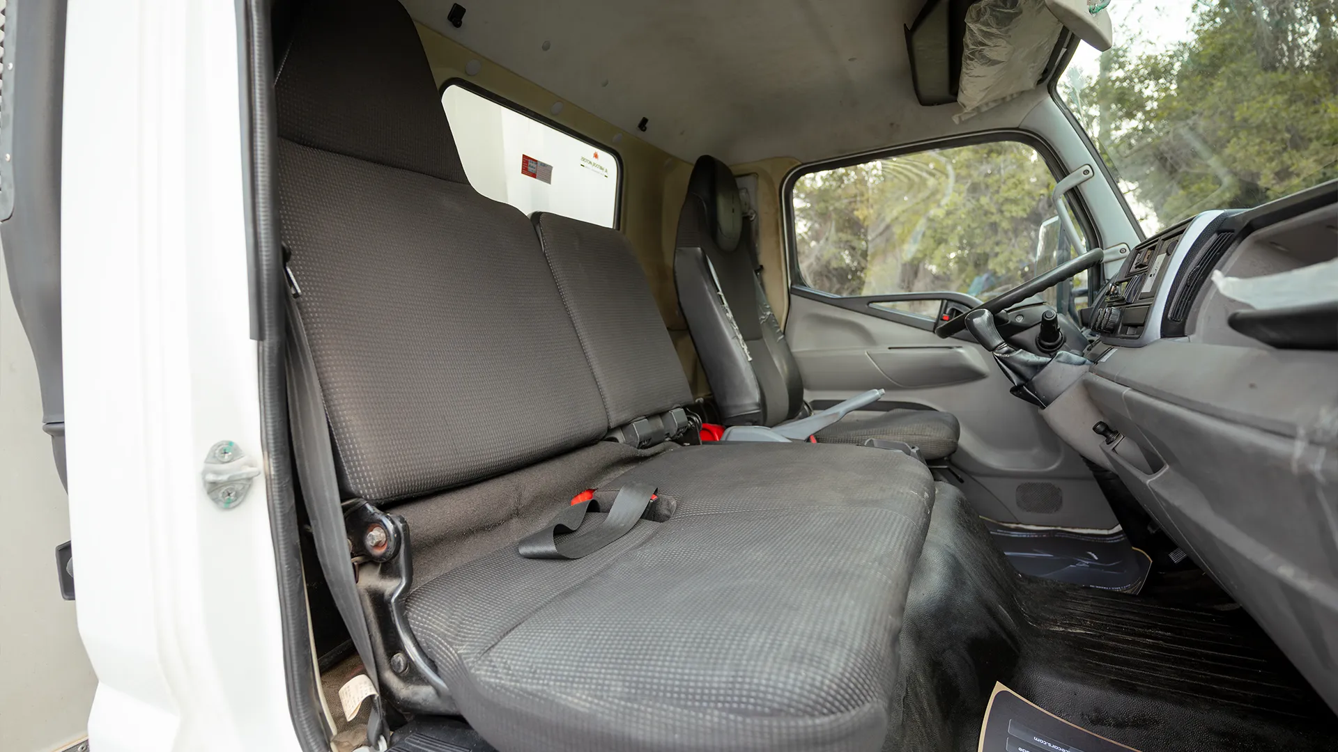 Used 2020 Mitsubishi Canter Chiller Box in White – Front Passenger Side Cabin View for Sale at First Choice Cars Dubai Sharjah
