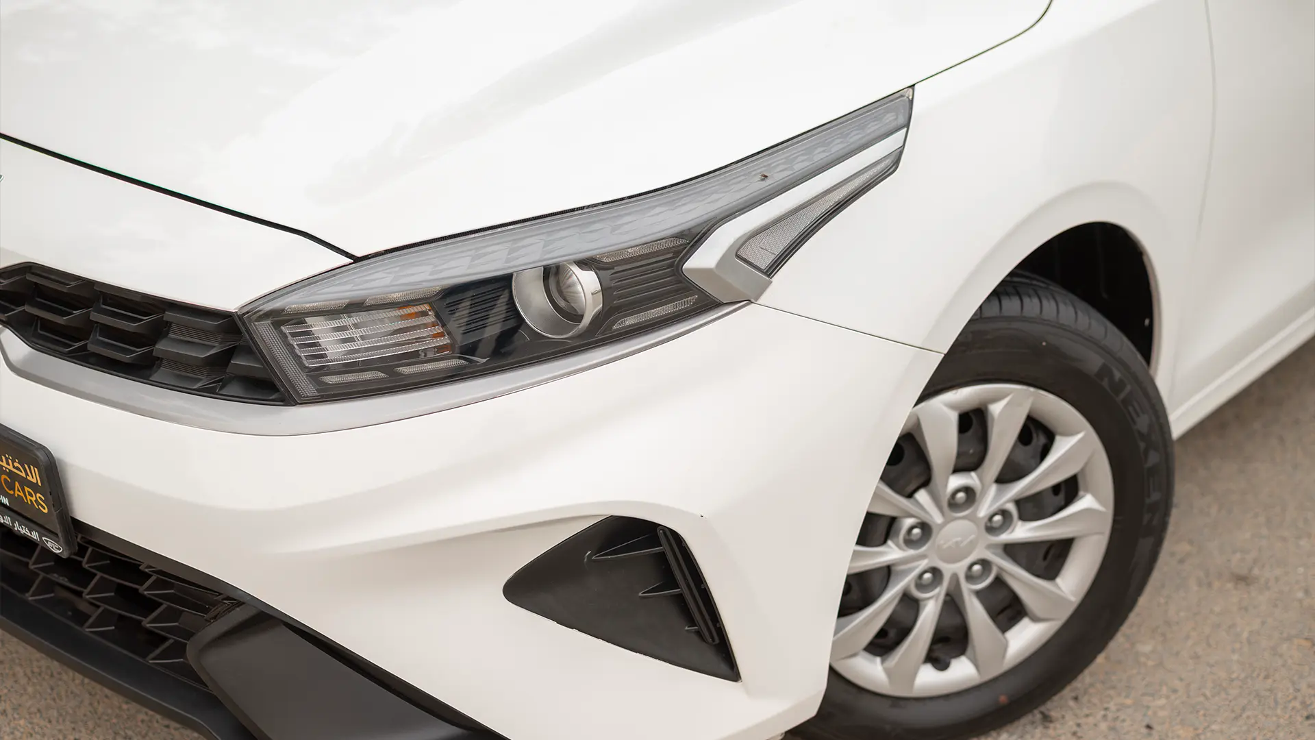 Used 2023 Kia Cerato LX in White – Headlight Close-up for Sale at First Choice Cars Dubai Sharjah