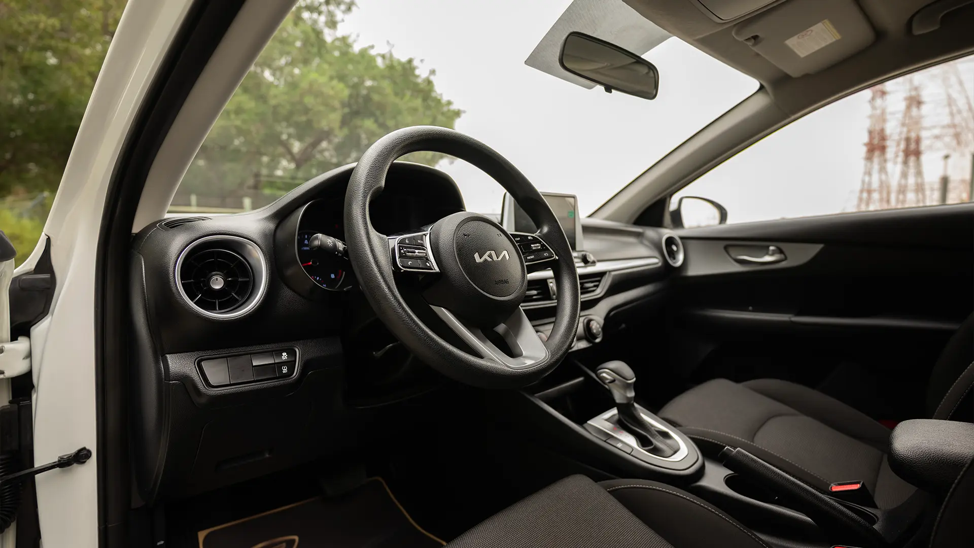 Used 2023 Kia Cerato LX in White – Driver Side Dashboard & Steering View for Sale at First Choice Cars Dubai Sharjah