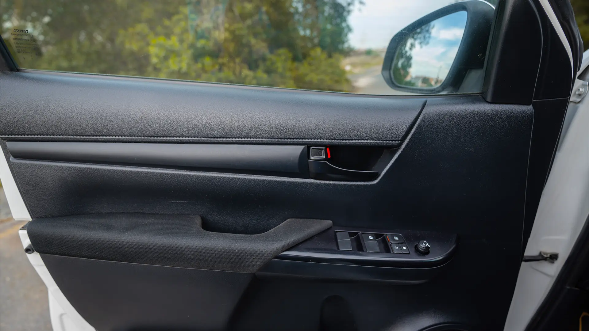 Used 2021 Toyota Hilux DLX Double Cabin in White – Driver Door Panel Full View for Sale at First Choice Cars Dubai Sharjah