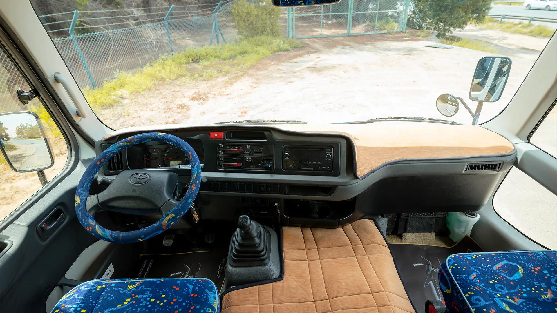 Used 2022 Toyota Coaster High Roof in White – Front Cabin / Dashboard Full View for Sale at First Choice Cars Dubai Sharjah