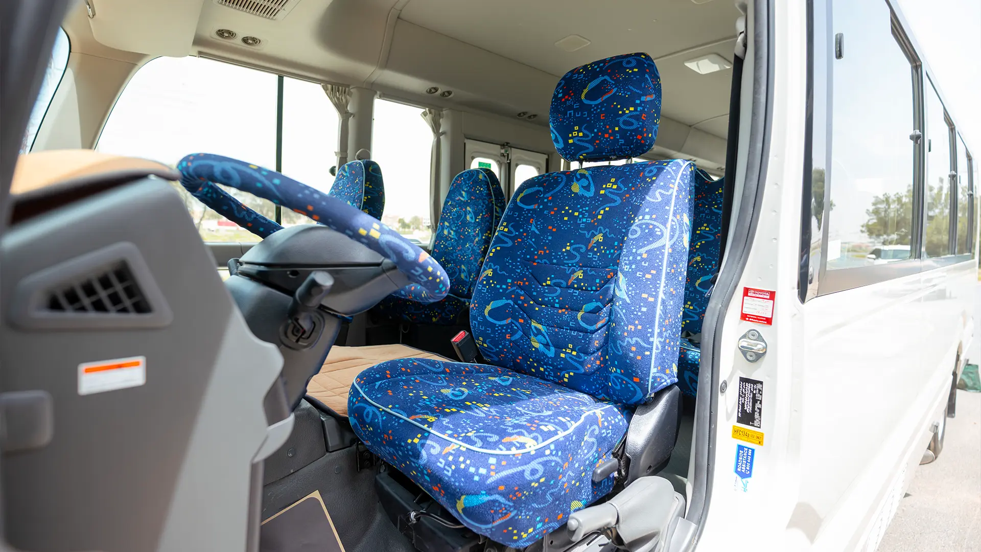 Used 2022 Toyota Coaster High Roof in White – Front Driver Side Cabin View for Sale at First Choice Cars Dubai Sharjah