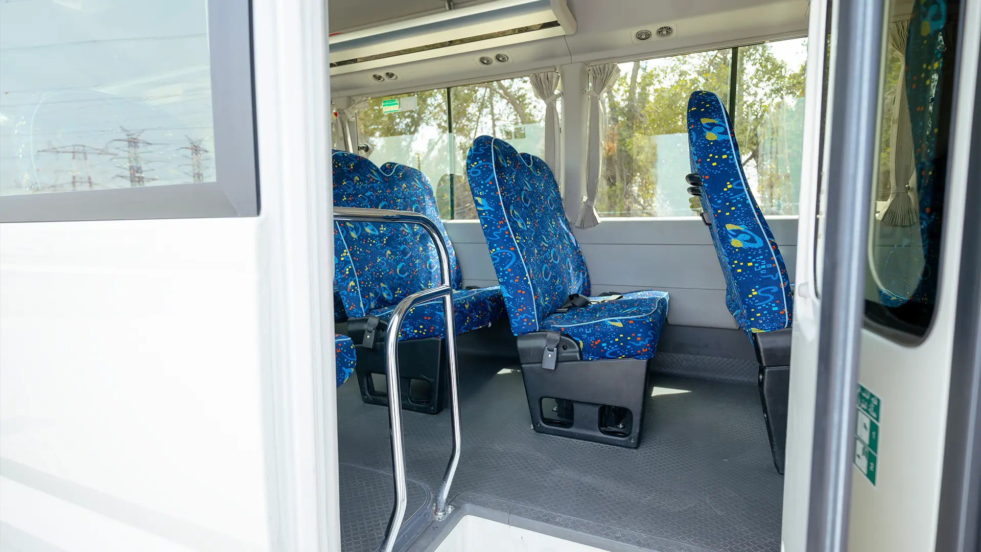 Used 2022 Toyota Coaster High Roof in White – Rear Passenger Side Cabin View for Sale at First Choice Cars Dubai Sharjah