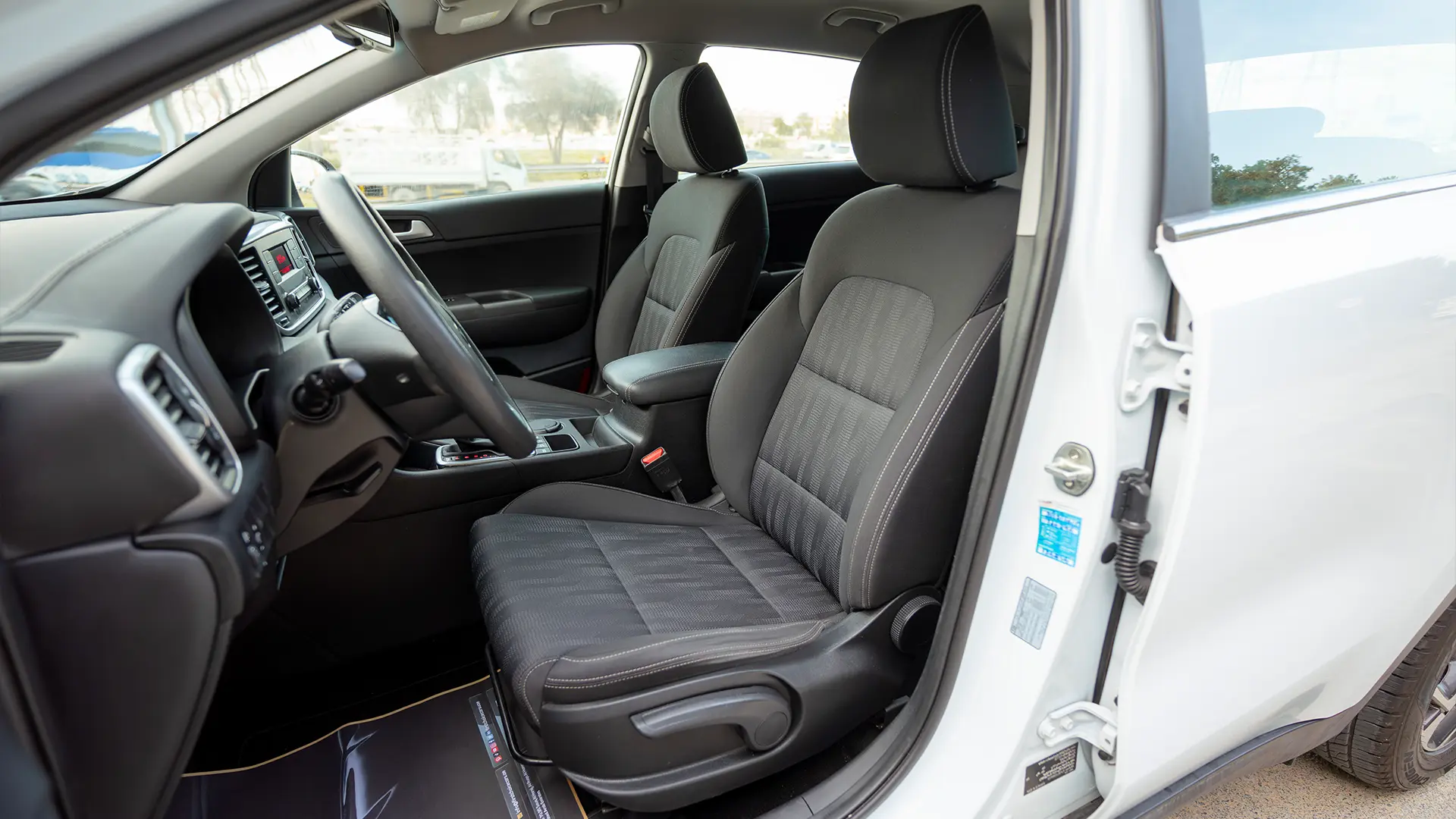 Used 2020 Kia Sportage LX in White – Front Driver Side Cabin View for Sale at First Choice Cars Dubai Sharjah