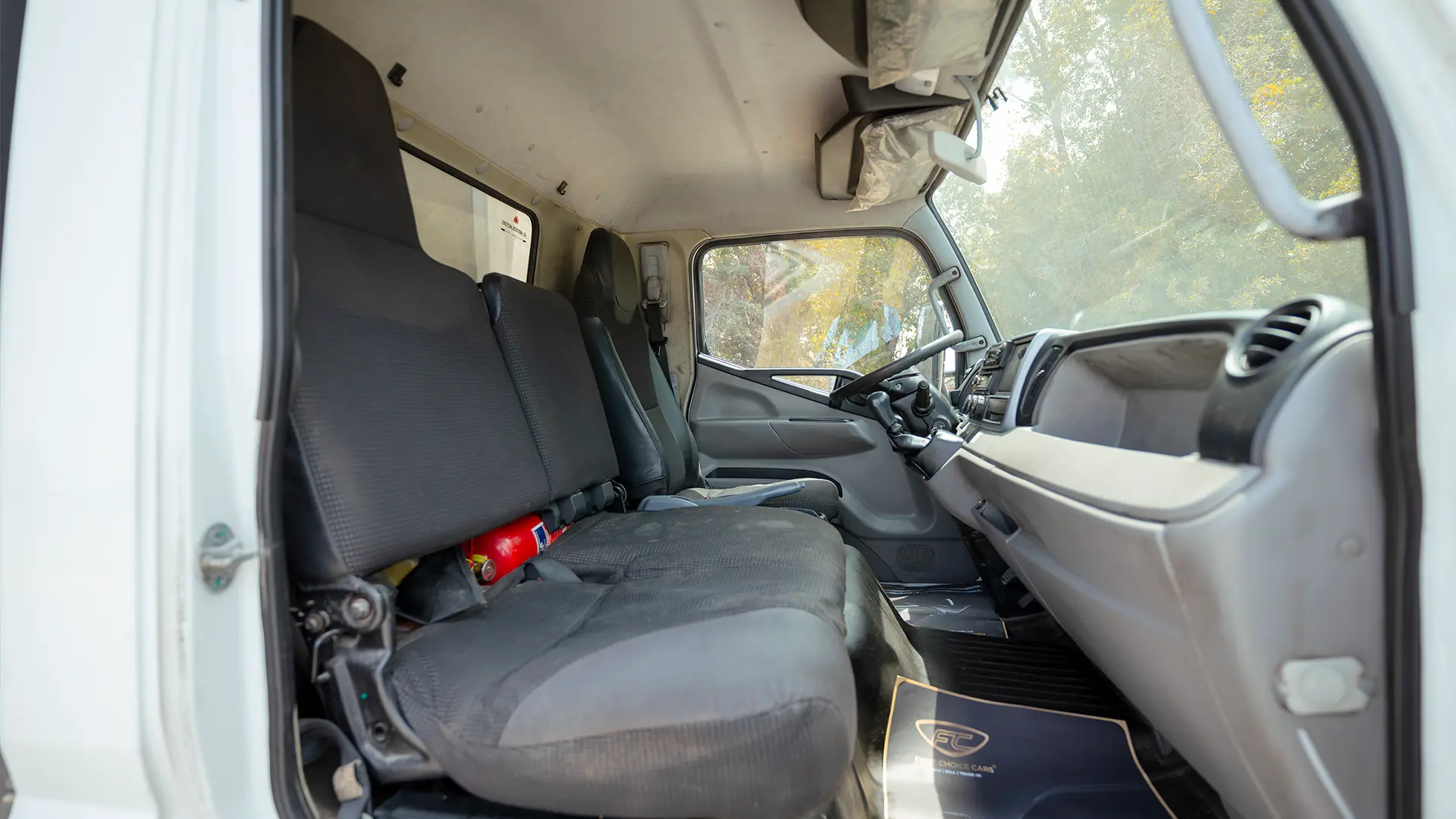 Used 2020 Mitsubishi Canter Chiller Box in White – Front Passenger Side Cabin View for Sale at First Choice Cars Dubai Sharjah
