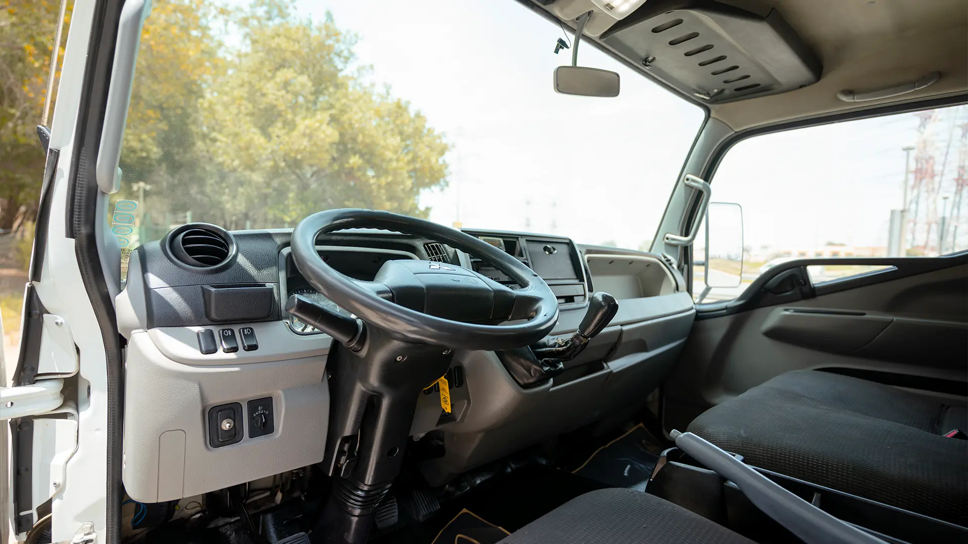 Used 2020 Mitsubishi Canter Chiller Box in White – Driver Side Dashboard & Steering View for Sale at First Choice Cars Dubai Sharjah