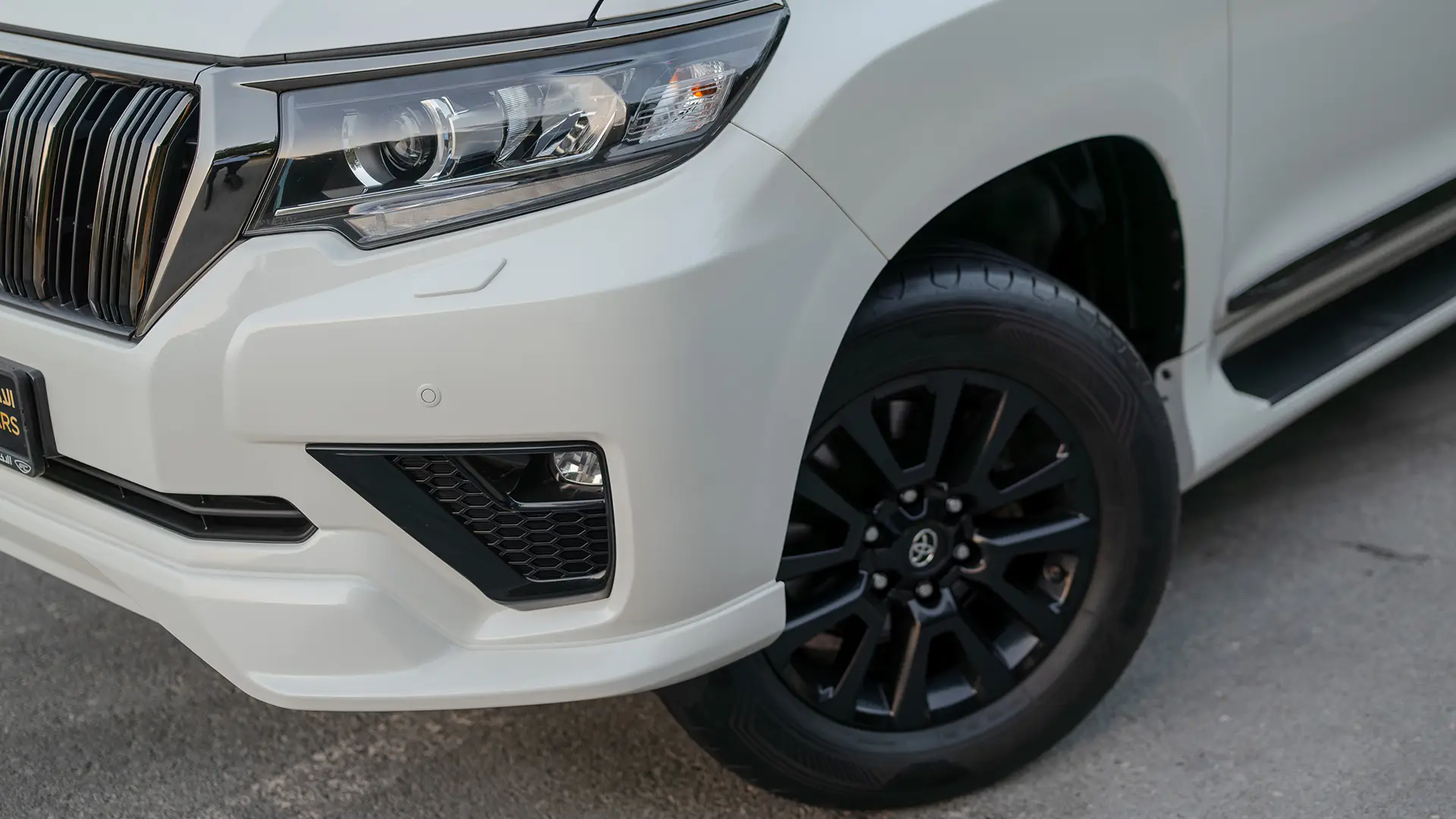 Used 2022 Toyota Prado VXR in White – Headlight Close-up for Sale at First Choice Cars Dubai Sharjah