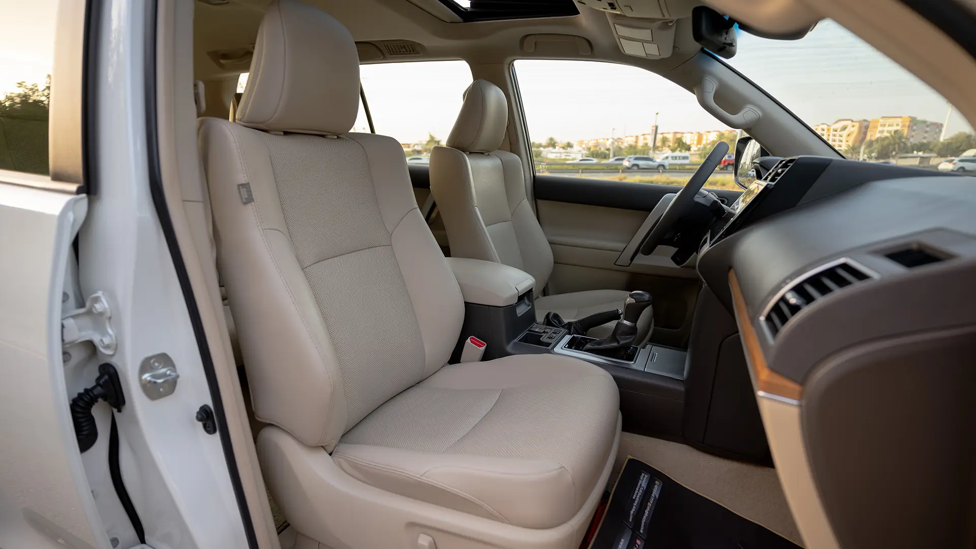 Used 2022 Toyota Prado VXR in White – Front Passenger Side Cabin View for Sale at First Choice Cars Dubai Sharjah