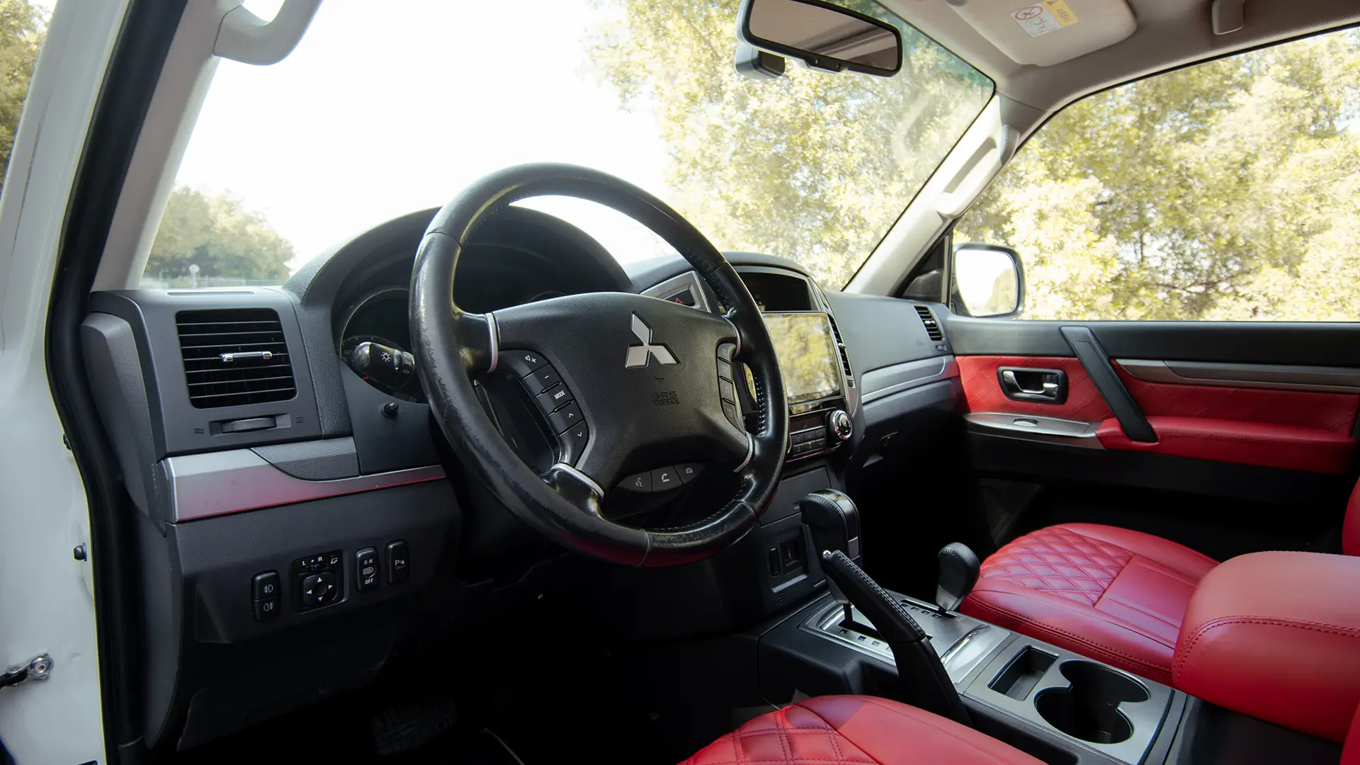 Used 2022 Mitsubishi Pajero GLS in White – Driver Side Dashboard & Steering View for Sale at First Choice Cars Dubai Sharjah