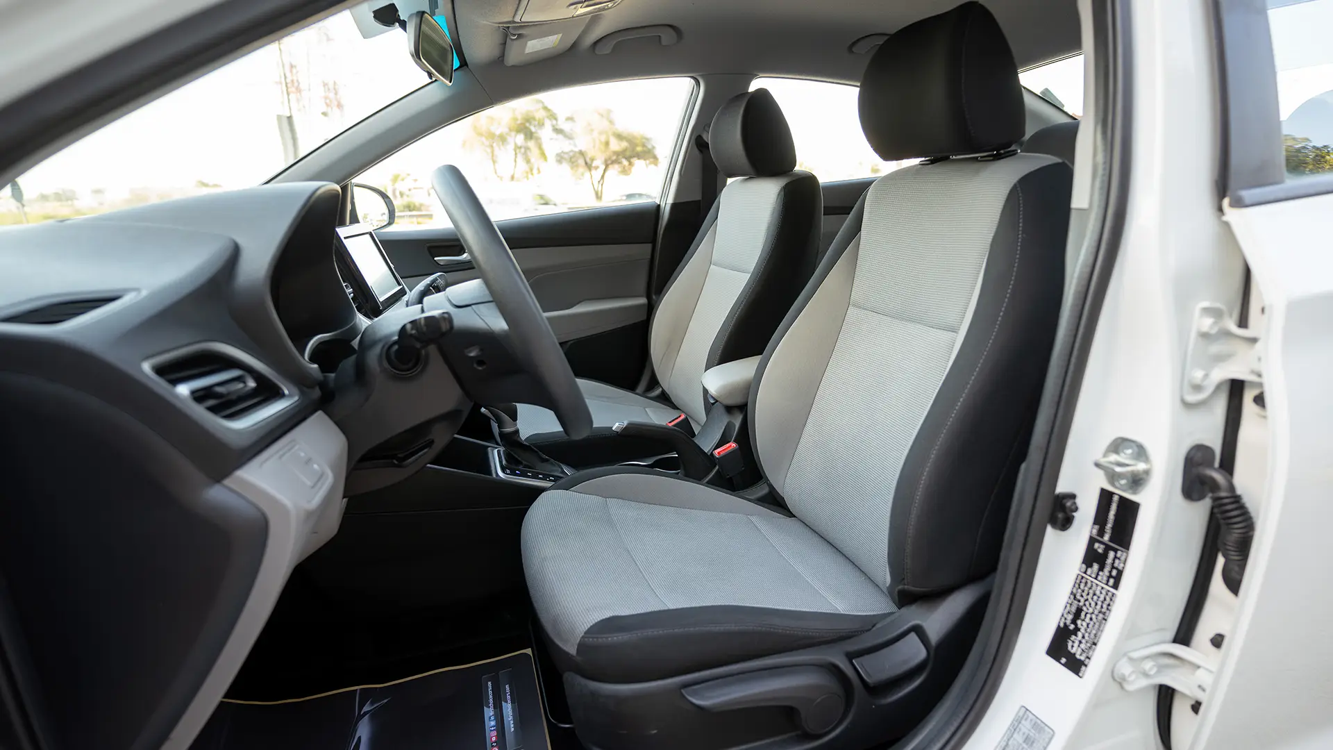 Used 2023 Hyundai Accent Smart in White – Front Driver Side Cabin View for Sale at First Choice Cars Dubai Sharjah