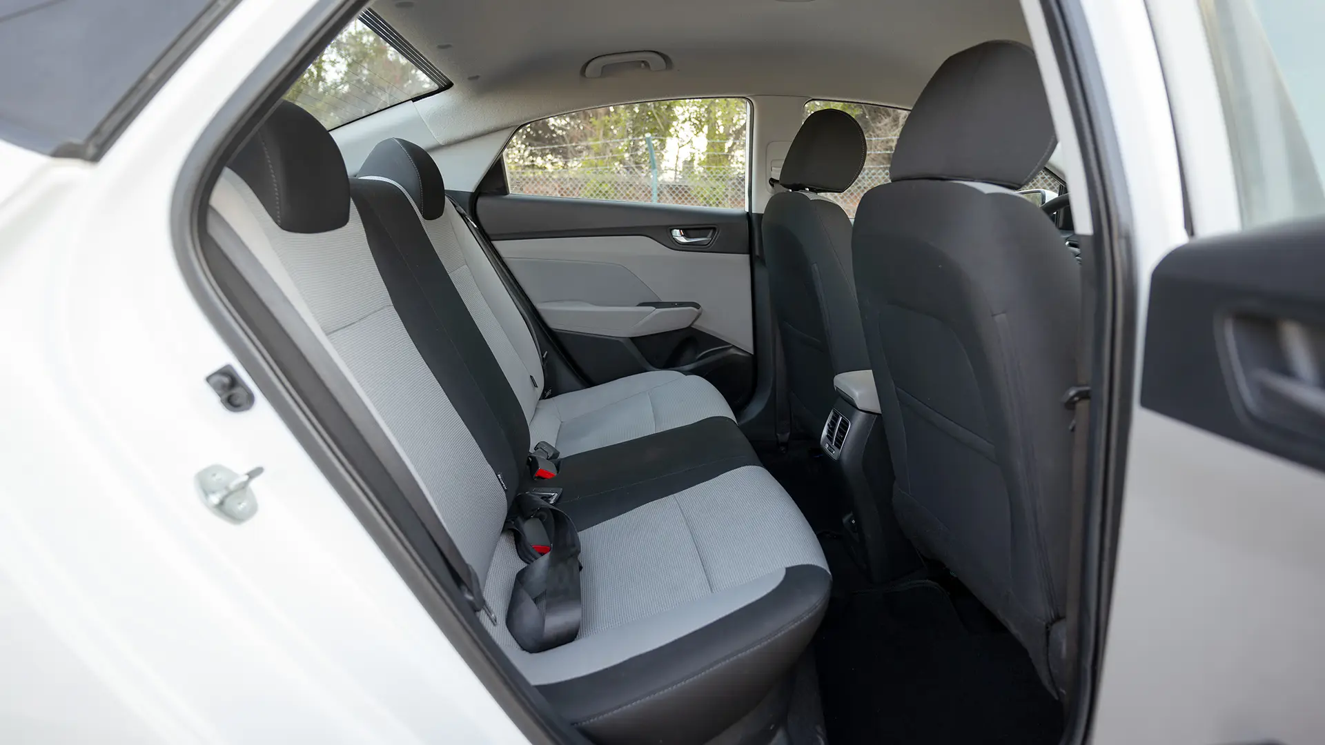 Used 2023 Hyundai Accent Smart in White – Rear Passenger Side Cabin View for Sale at First Choice Cars Dubai Sharjah