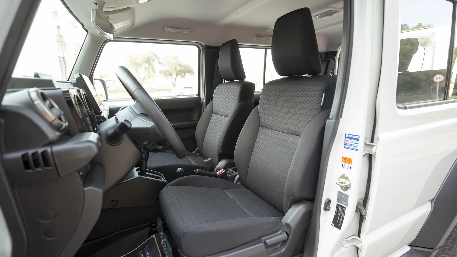 Used 2024 Suzuki Jimny GLX in White – Front Driver Side Cabin View for Sale at First Choice Cars Dubai Sharjah
