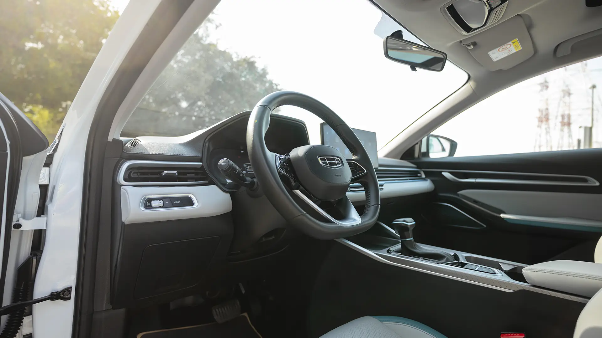 Used 2025 Geely Emgrand GF in White – Driver Side Dashboard & Steering View for Sale at First Choice Cars Dubai Sharjah