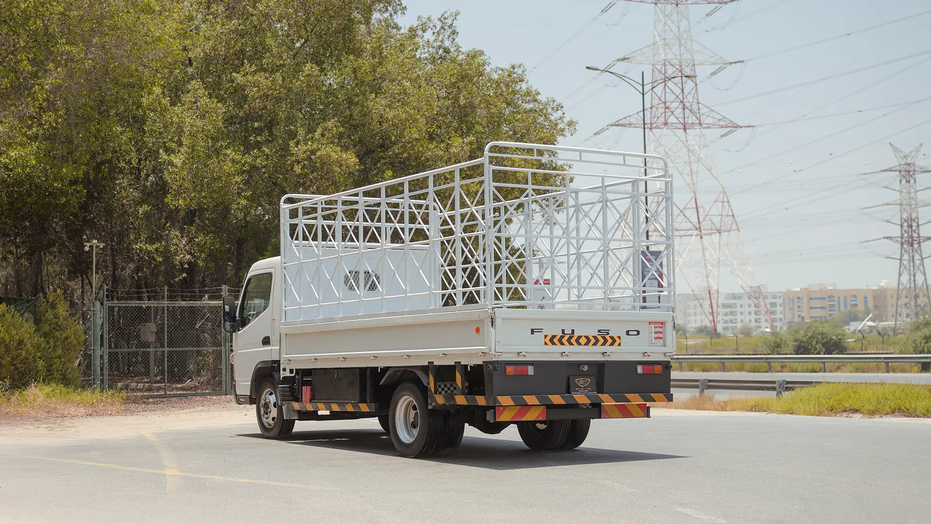Used 2024 Mitsubishi Canter Cargo Body in White – Left Back Diagonal (45°) View for Sale at First Choice Cars Dubai Sharjah