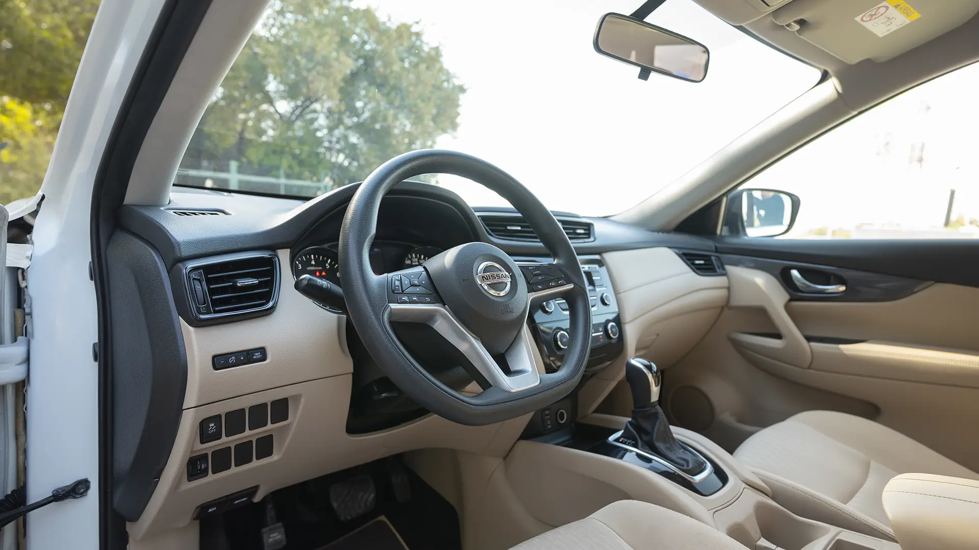Used 2022 Nissan X-Trail S in White – Driver Side Dashboard & Steering View for Sale at First Choice Cars Dubai Sharjah