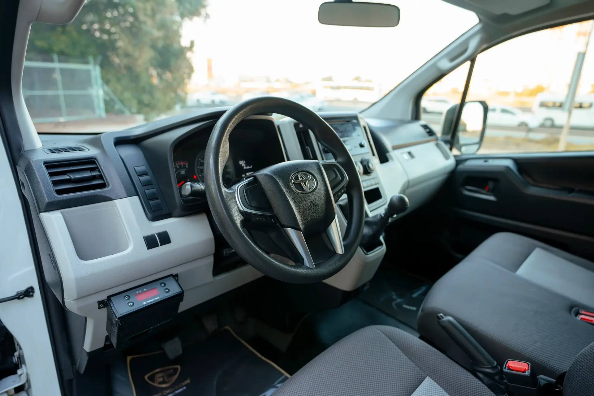 Used 2020 Toyota Hiace GLX High Roof in White – Driver Side Dashboard & Steering View for Sale at First Choice Cars Dubai Sharjah