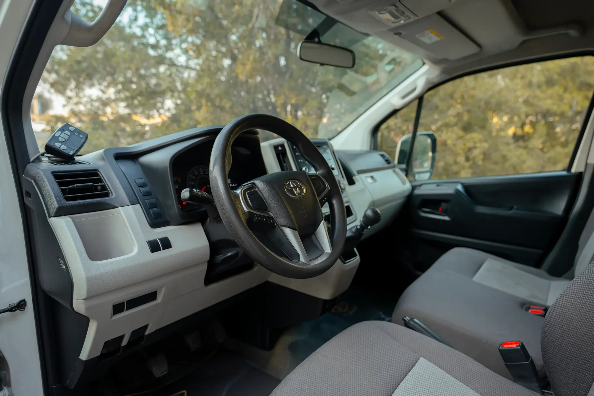 Used 2020 Toyota Hiace GLX High Roof in White – Driver Side Dashboard & Steering View for Sale at First Choice Cars Dubai Sharjah