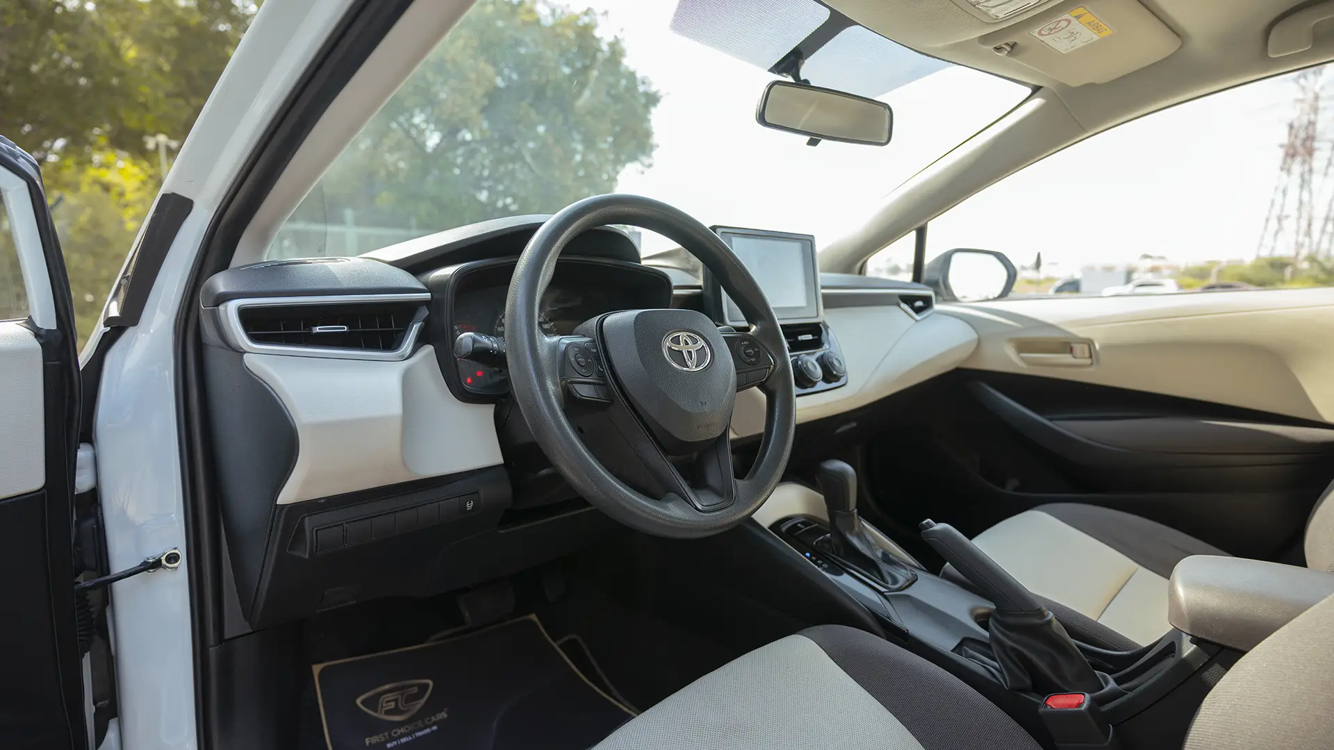 Used 2024 Toyota Corolla XLI in White – Driver Side Dashboard & Steering View for Sale at First Choice Cars Dubai Sharjah