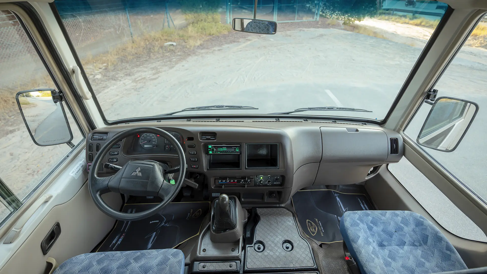 Used 2023 Mitsubishi Rosa Standard in White – Front Cabin / Dashboard Full View for Sale at First Choice Cars Dubai Sharjah