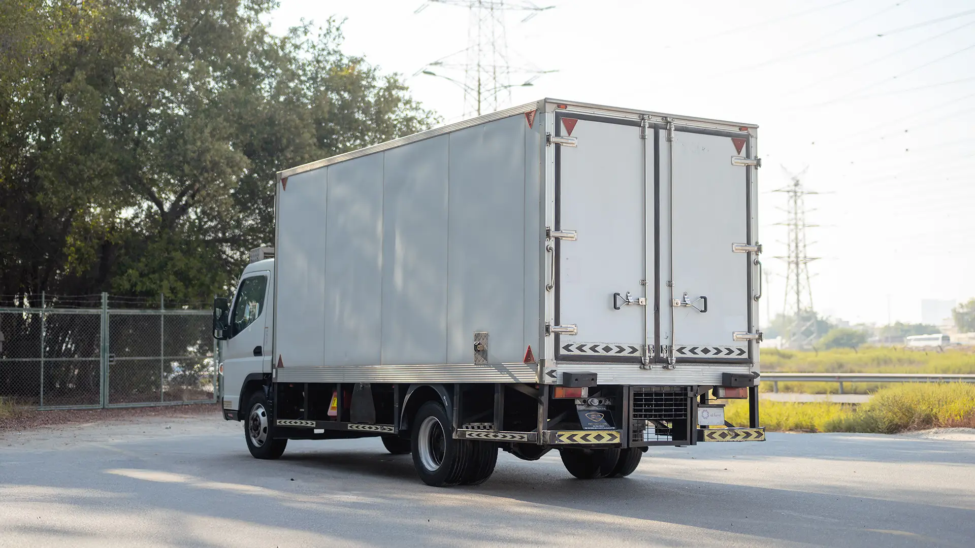 Used 2022 Mitsubishi Canter Chiller Box in White – Left Back Diagonal (45°) View for Sale at First Choice Cars Dubai Sharjah