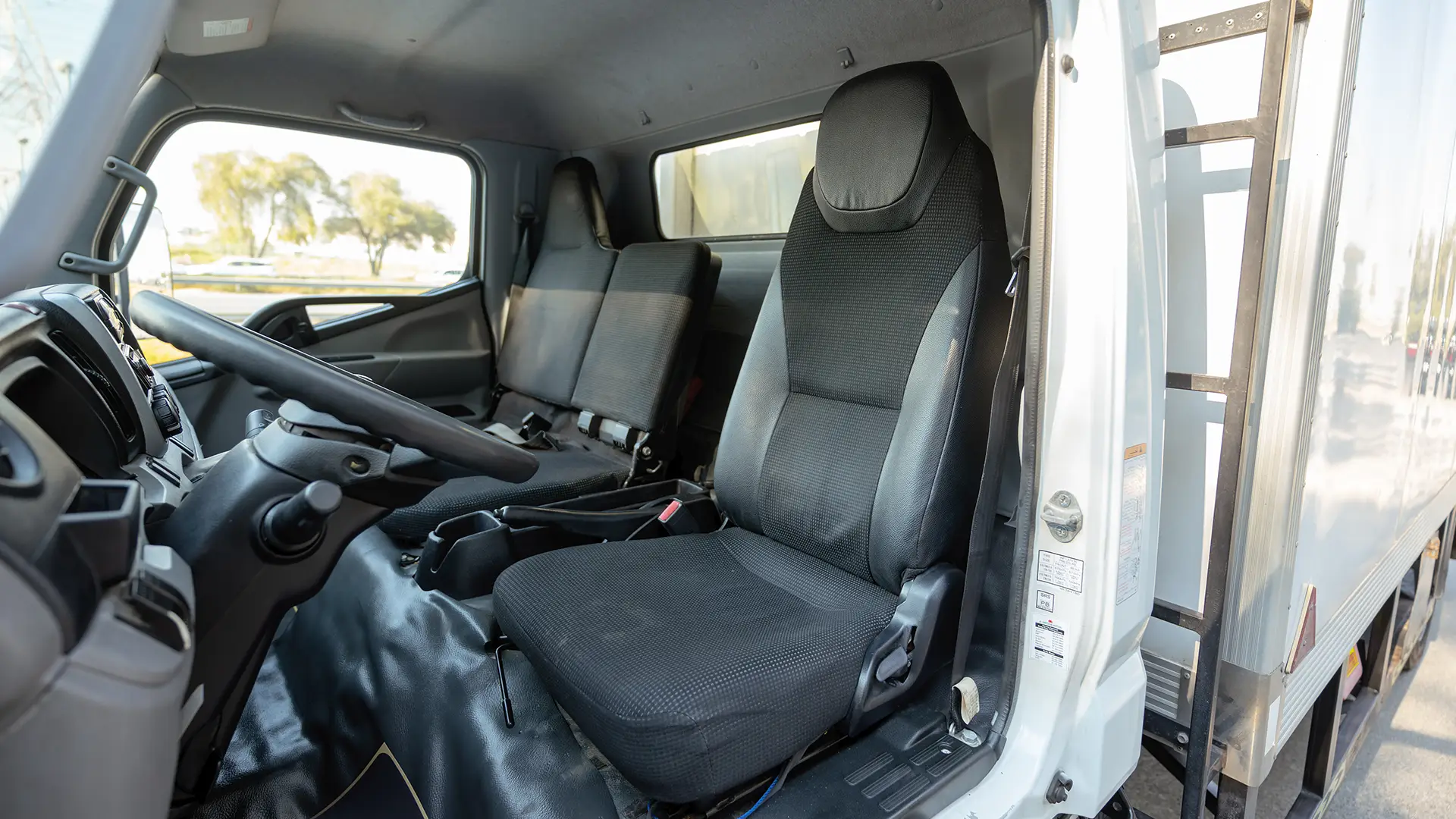 Used 2022 Mitsubishi Canter Chiller Box in White – Front Driver Side Cabin View for Sale at First Choice Cars Dubai Sharjah