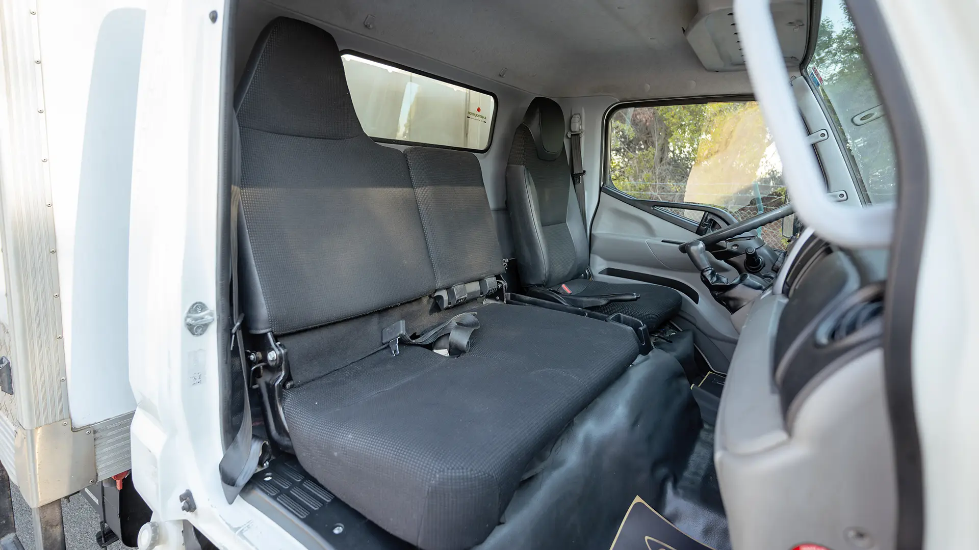 Used 2022 Mitsubishi Canter Chiller Box in White – Front Passenger Side Cabin View for Sale at First Choice Cars Dubai Sharjah