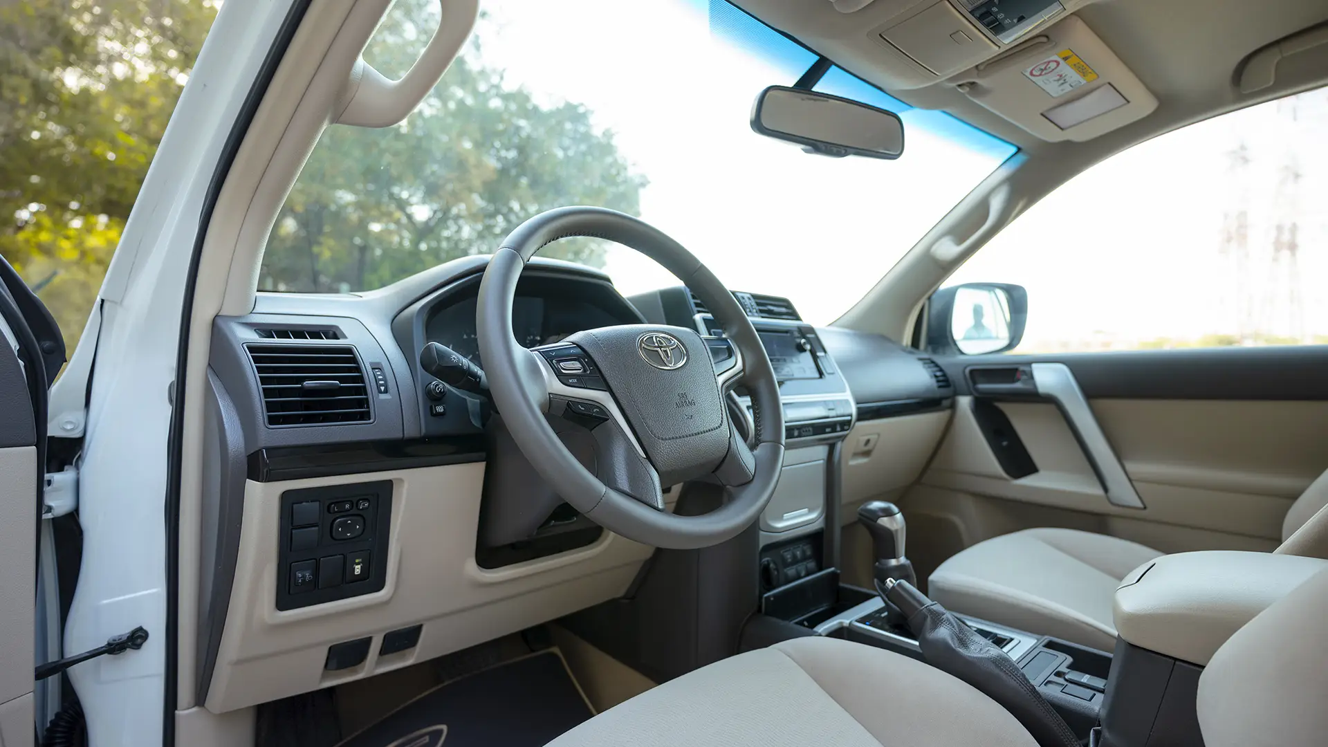 Used 2019 Toyota Prado EXR in White – Driver Side Dashboard & Steering View for Sale at First Choice Cars Dubai Sharjah
