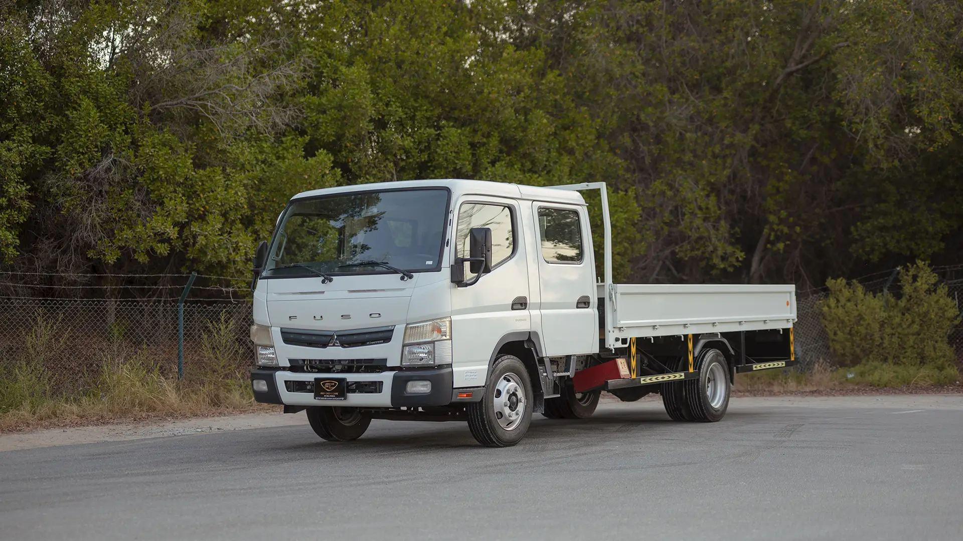 Used 2024 Mitsubishi Canter Double Cabin Cargo Body in White – Left Front Diagonal (45°) View for Sale at First Choice Cars Dubai Sharjah